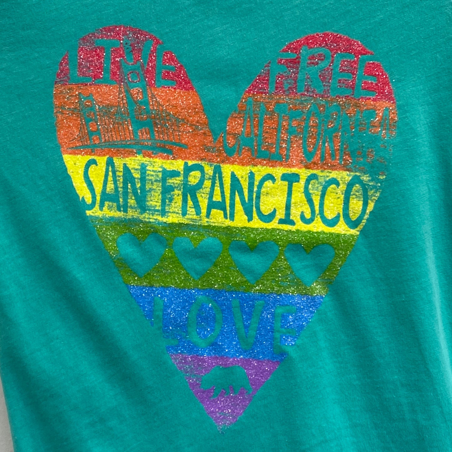 Girl's San Francisco t-shirt with colorful heart design featuring Golden Gate Bridge, "Live Free California" text, and rainbow stripes