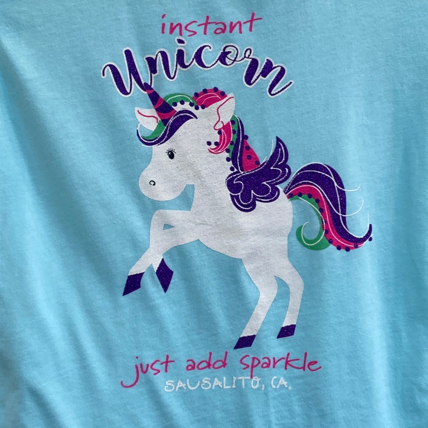 Sausalito unicorn t-shirt for girls featuring colorful unicorn graphic, "Instant unicorn" text, and "just add sparkle" slogan