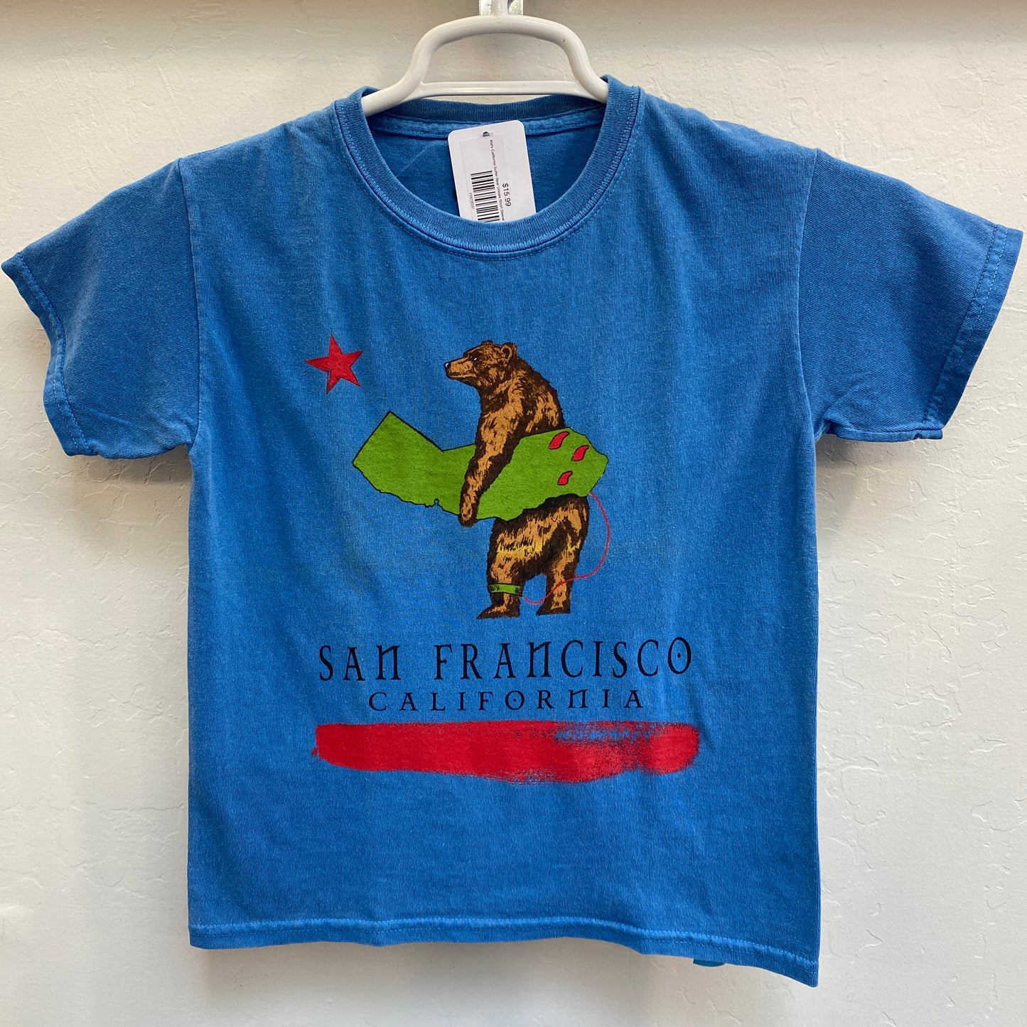 Blue kids' t-shirt with surfing bear holding California-shaped board, San Francisco text, cotton garment-dyed design