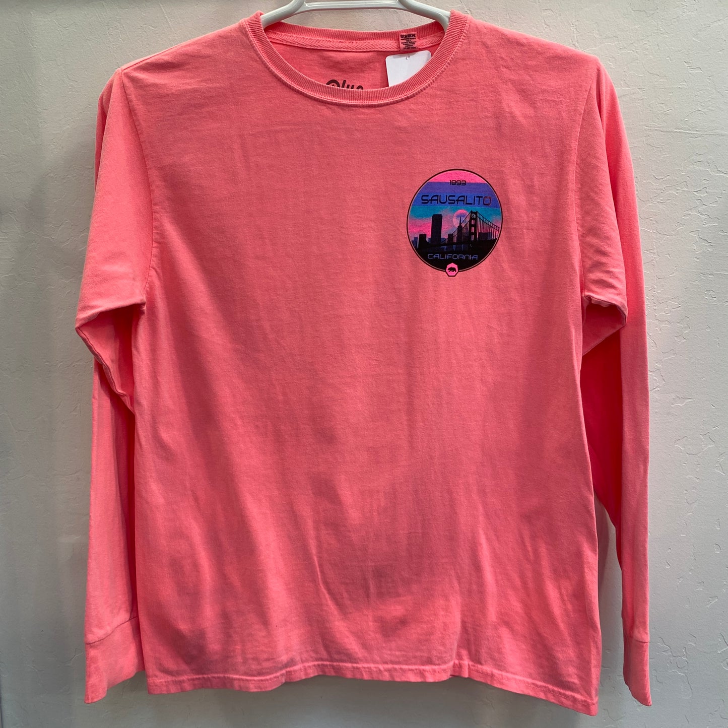 Pink long sleeve t-shirt with Sausalito San Francisco skyline logo, featuring Golden Gate Bridge on chest pocket
