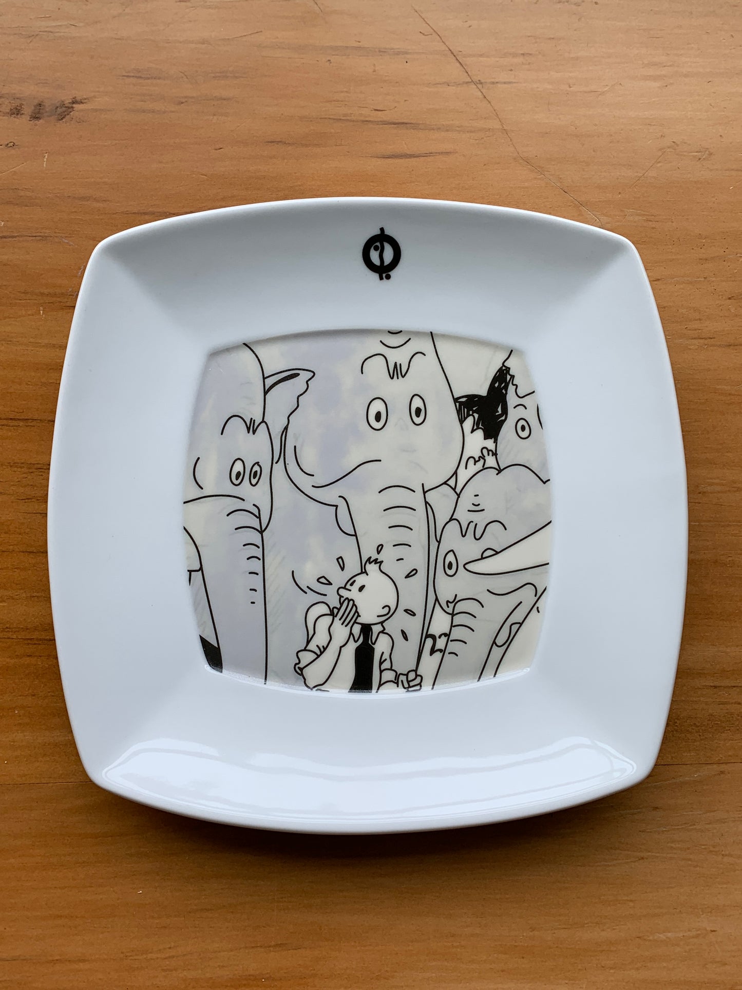 Tintin and Elephants tableware: Square white plate with cartoon illustration of character surrounded by elephants