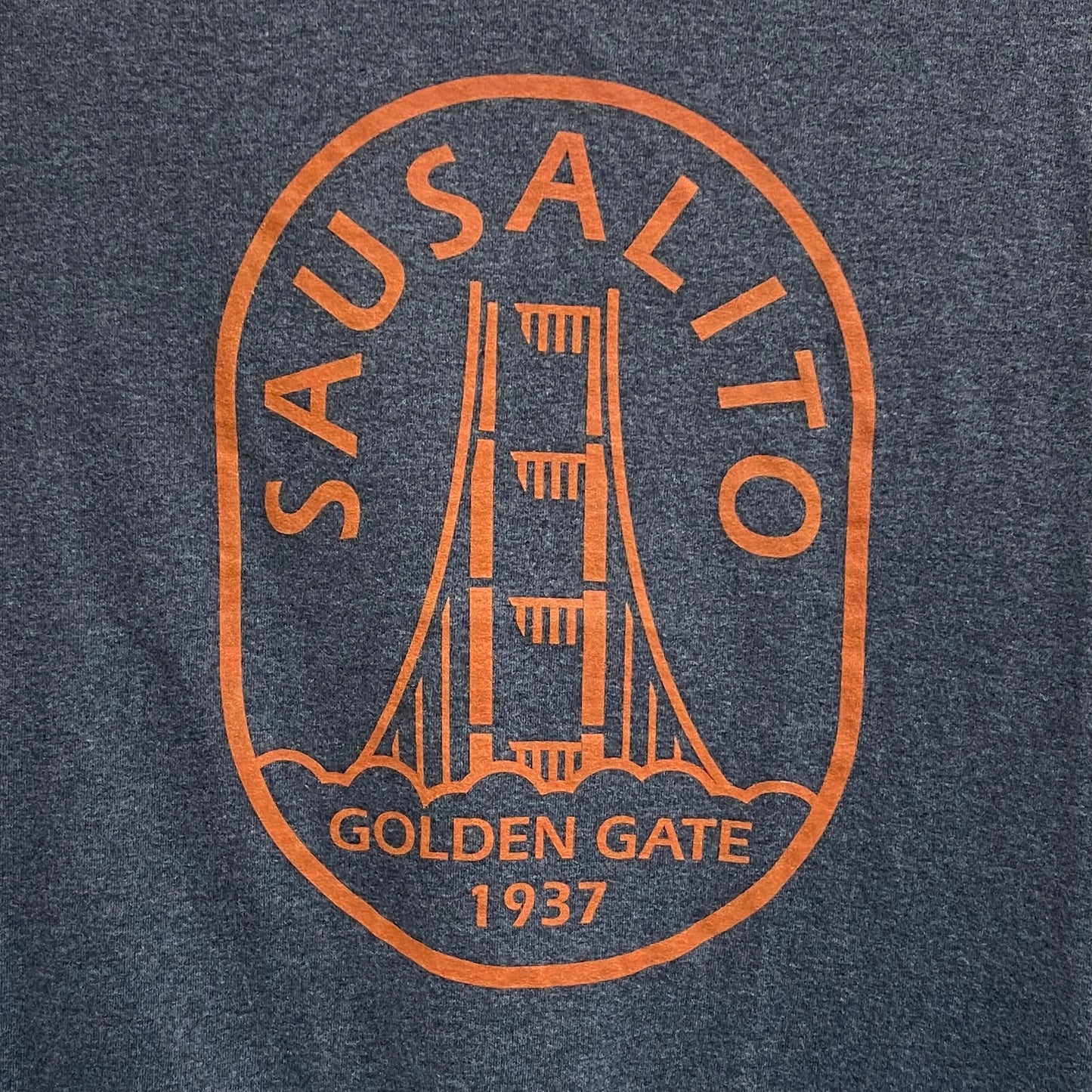 Sausalito retro t-shirt design featuring Golden Gate Bridge tower, orange print on gray fabric, commemorating 1937 completion