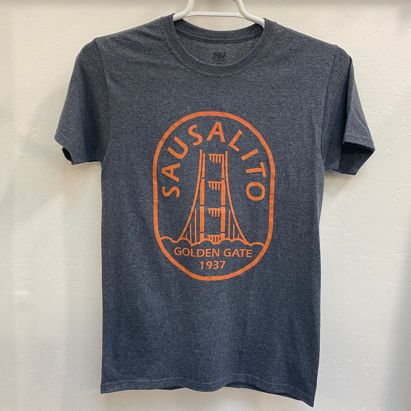 Sausalito retro t-shirt with Golden Gate Bridge logo, charcoal gray with orange print, hanging on display