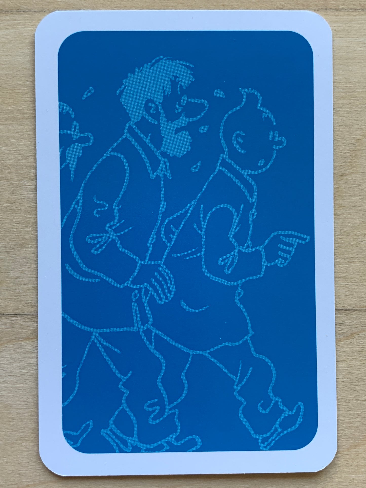 Tintin playing card featuring blue silhouette of characters from the comic series on bridge-sized card