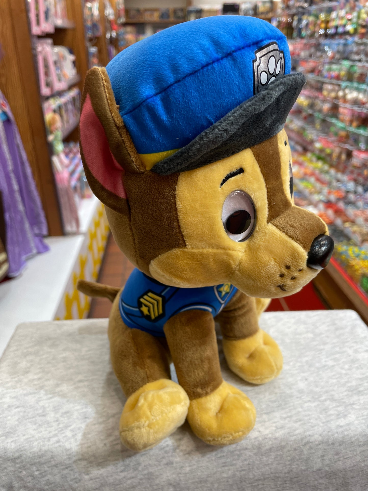 Gund Paw Patrol Chase plush toy in police uniform, sitting on display in toy store
