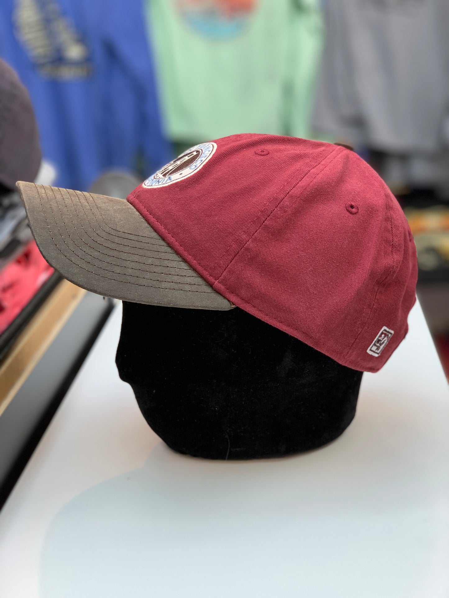 Red cotton baseball cap with Golden Gate Bridge embroidered patch, brown brim, and adjustable strap for San Francisco souvenir