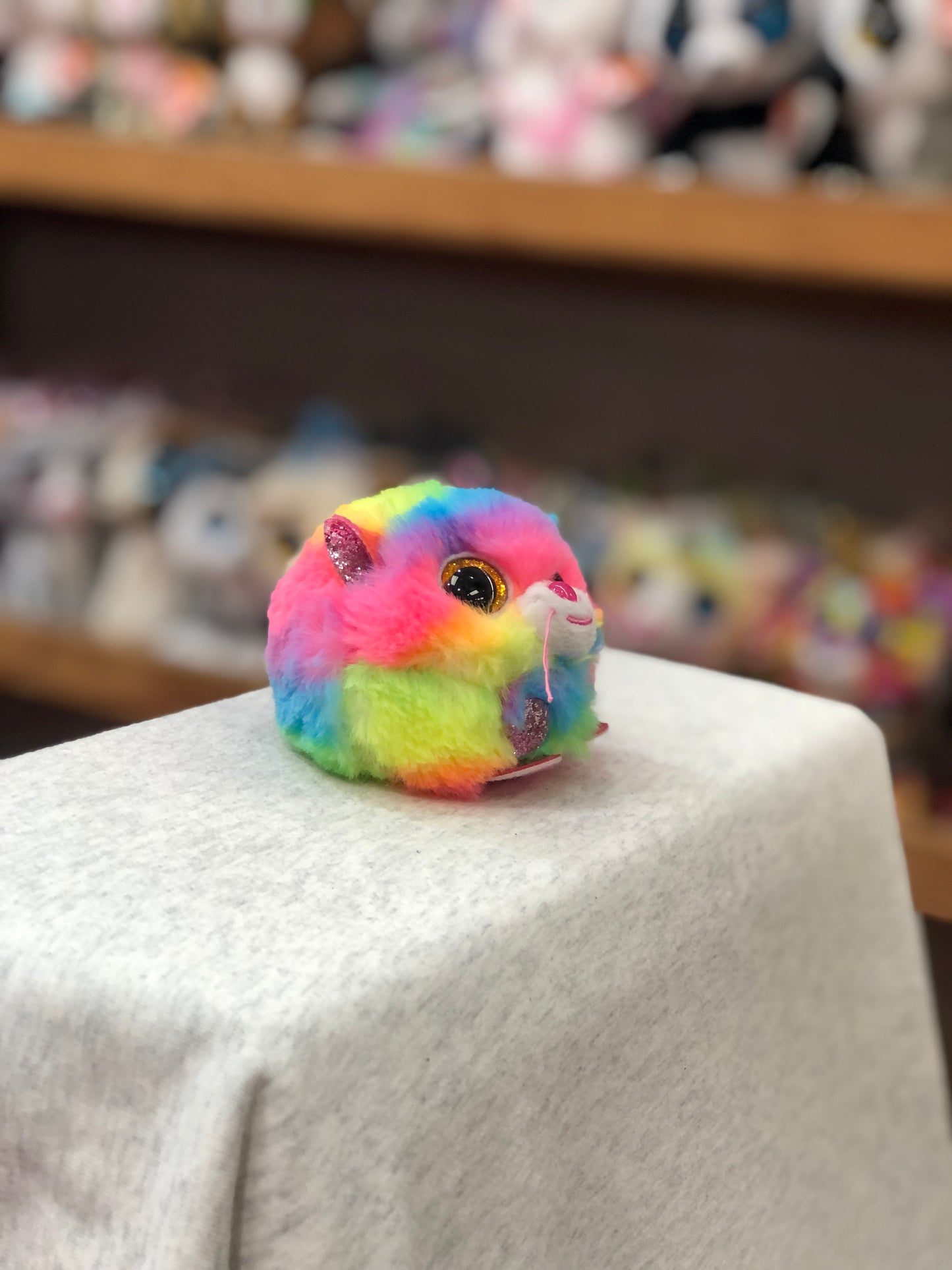 Colorful Ty Puffies Gizmo rainbow cat plush toy on display, showcasing vibrant fur and cute features for fun playtime