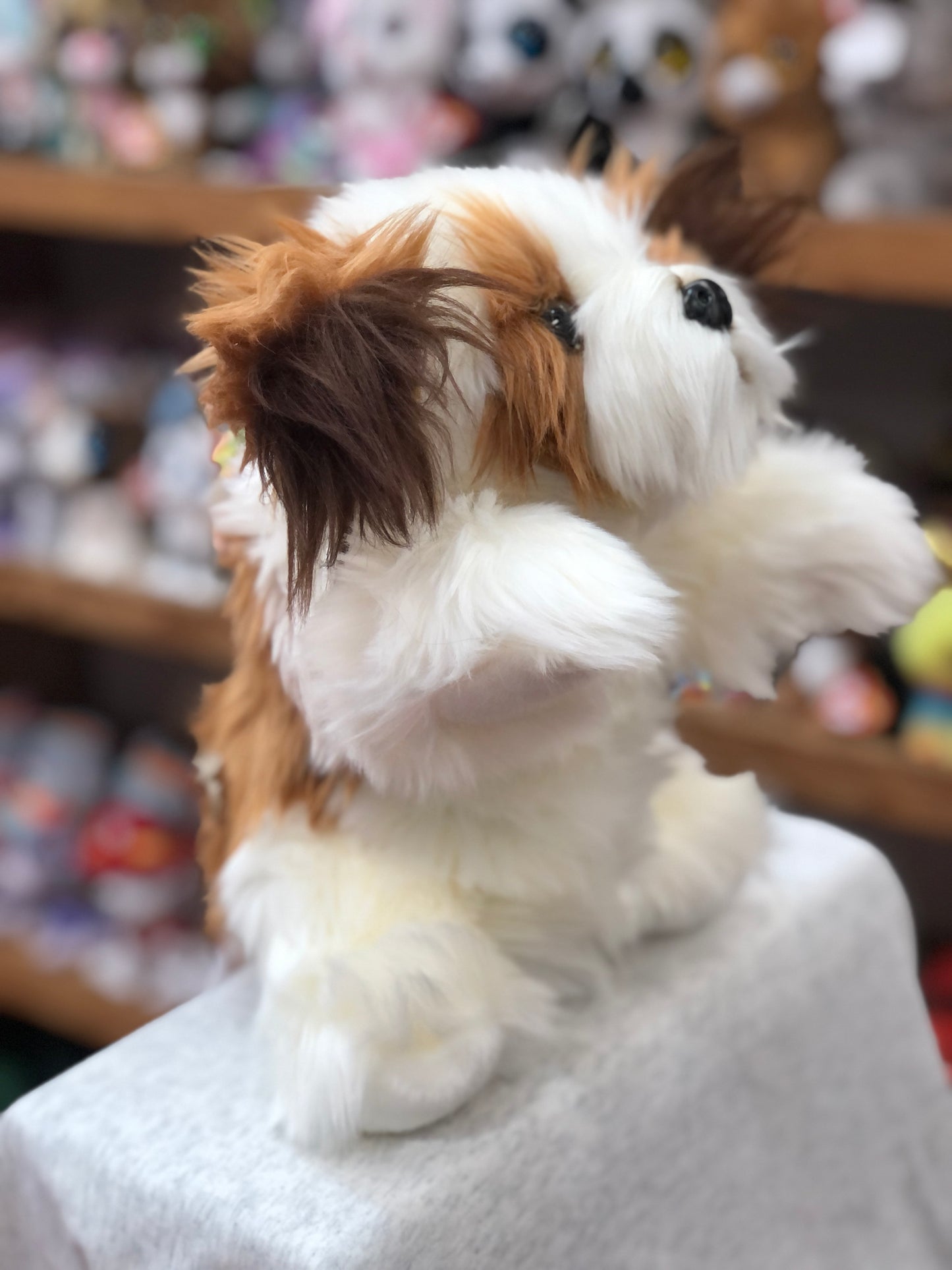 Cuddly brown and white dog puppet with fluffy fur, showcasing The Puppet Company's full-bodied animal design for interactive play