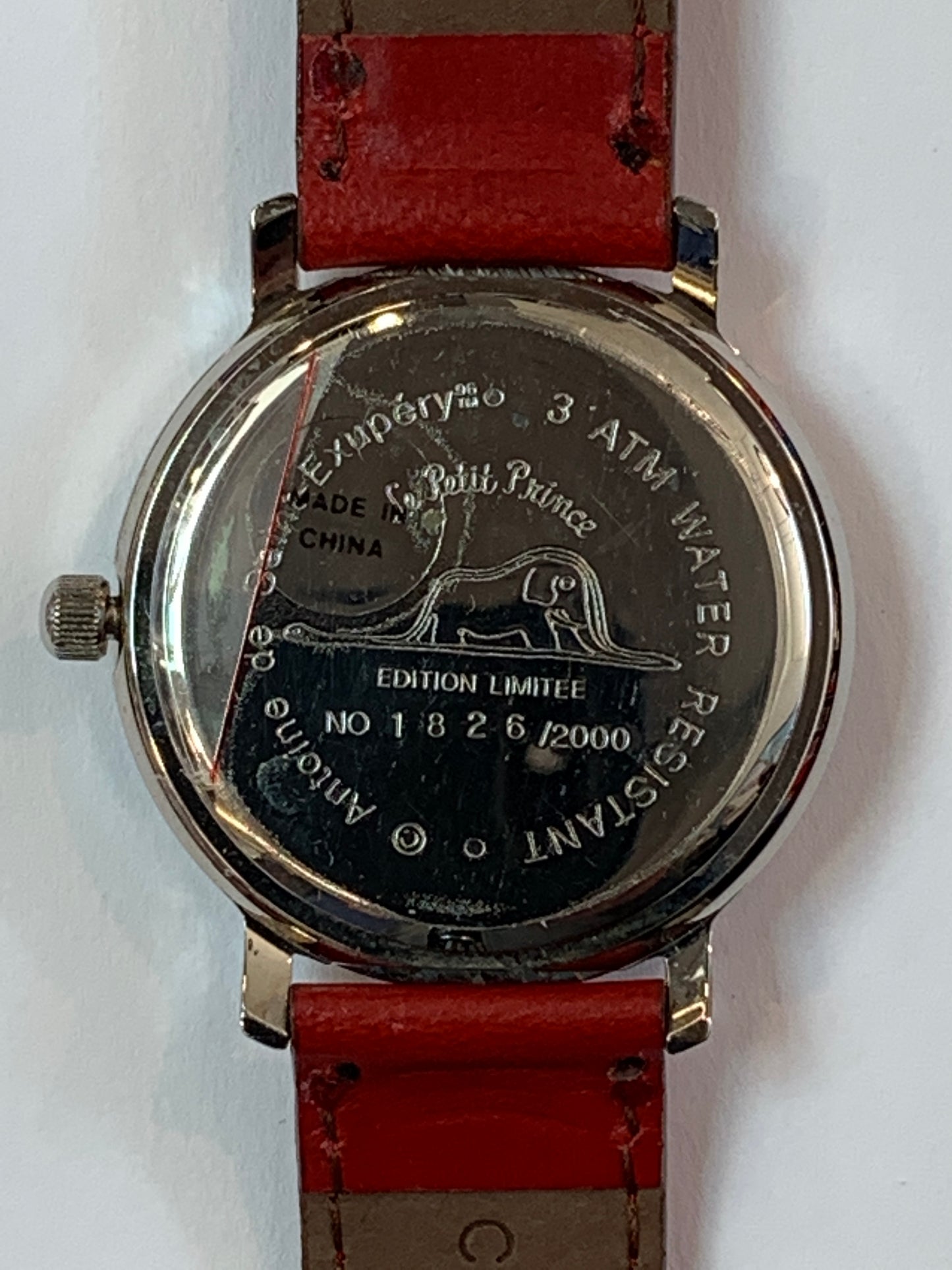 Limited edition Le Petit Prince watch back, showing serial number 1826/2000 and iconic elephant-in-boa illustration on stainless steel case