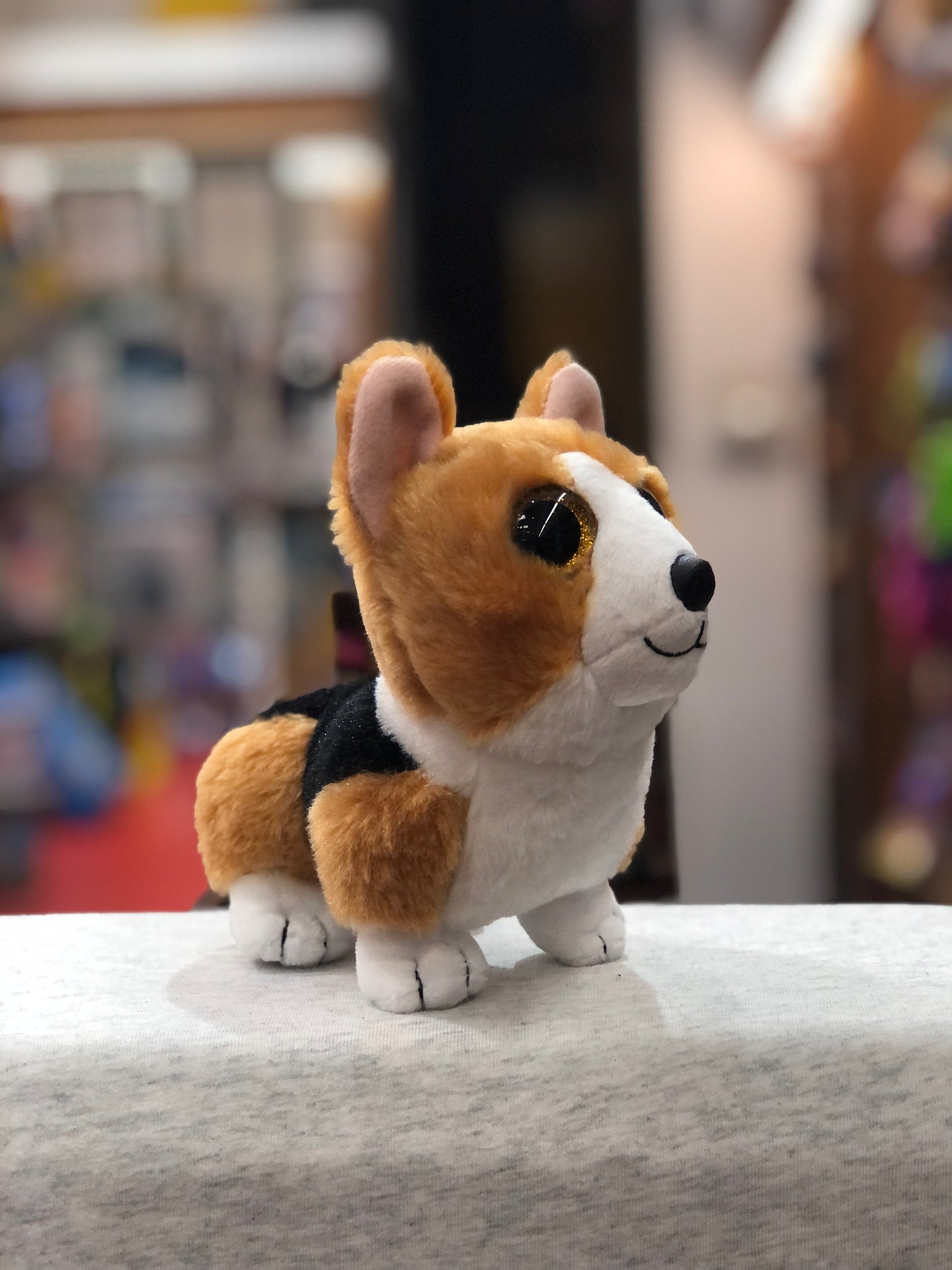 Ty Beanie Baby Colin Corgi plush toy, smiling with big eyes, on display in toy store