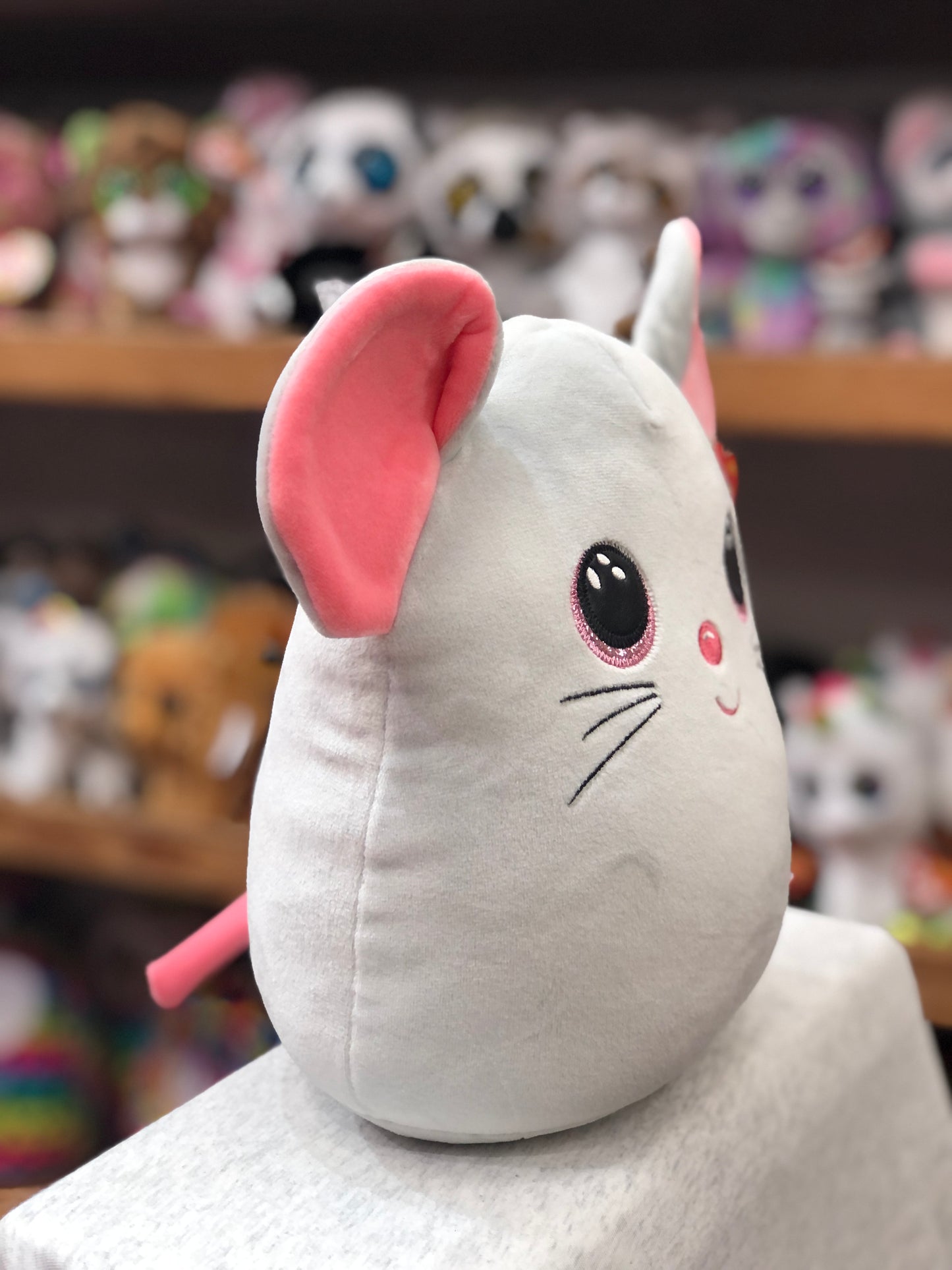 Ty Squish-a-Boo Catnip Mouse plush toy with sparkly pink eyes and ears, displayed on shelf with other plushies