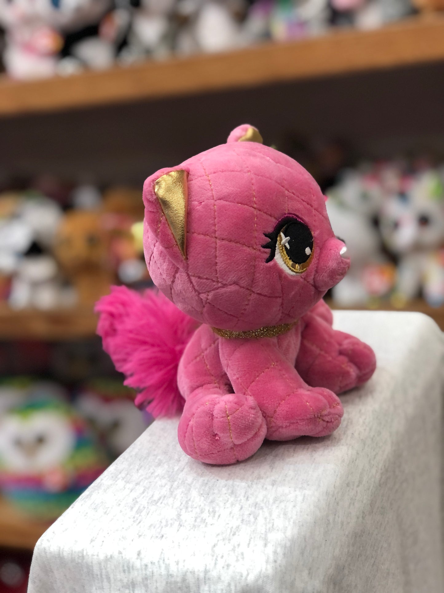 Pink plush cat Madame Purrnel with gold accents, sparkly eyes, and fluffy tail, part of P.Lushes Pets designer collection