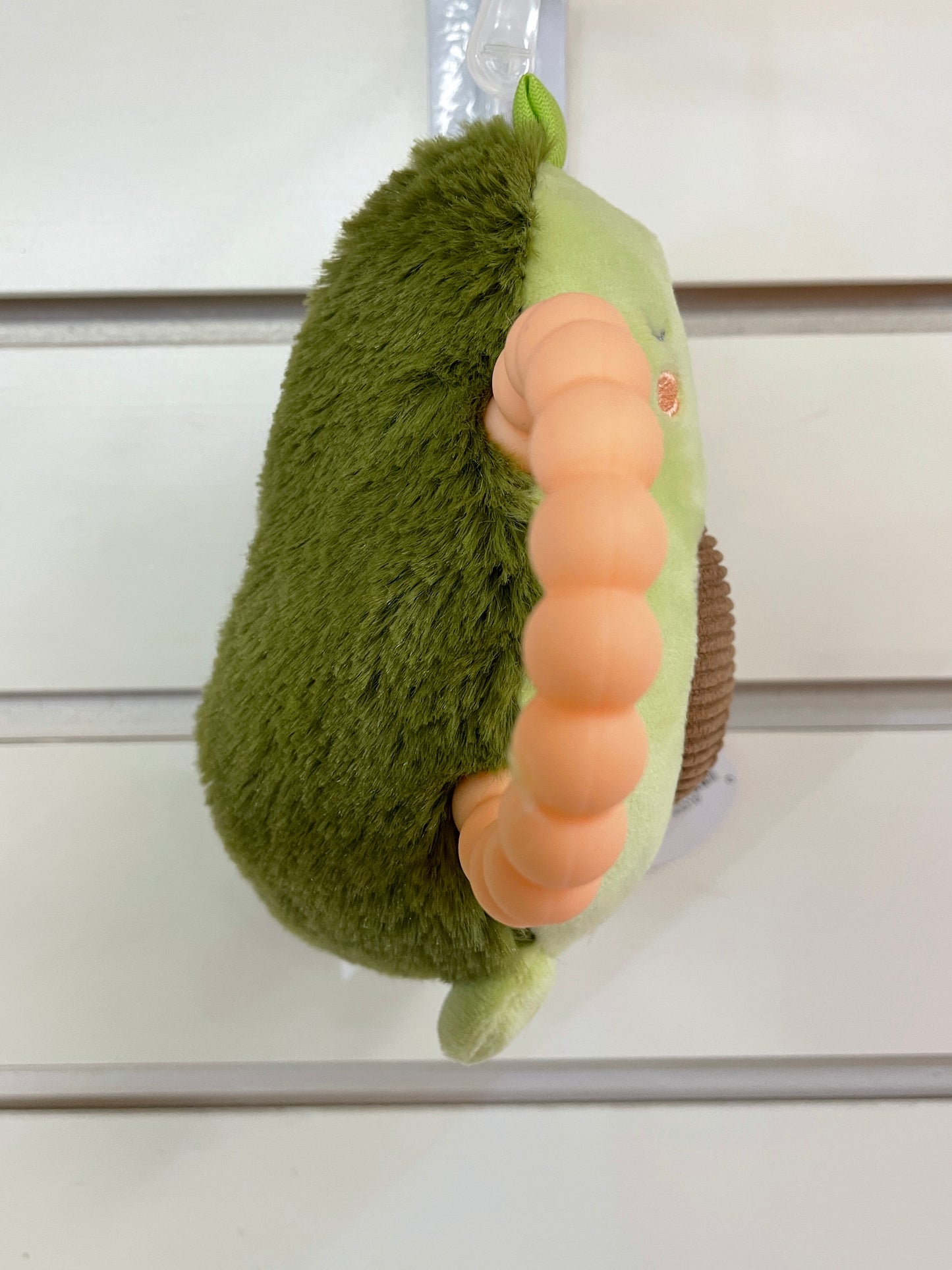 Mary Meyer Baby Yummy Avocado Rattle, green plush toy with peach teether, hanging from loop, 6 inches tall