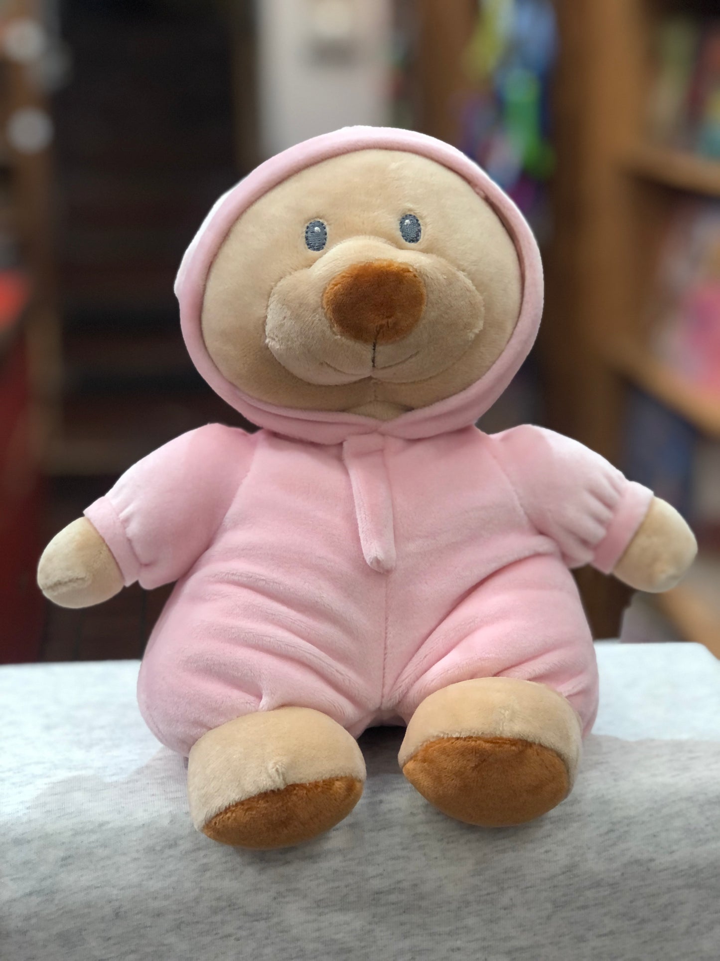 Soft plush Ty Baby PJ Bear in pink hooded pajamas, perfect newborn companion, sitting on white surface