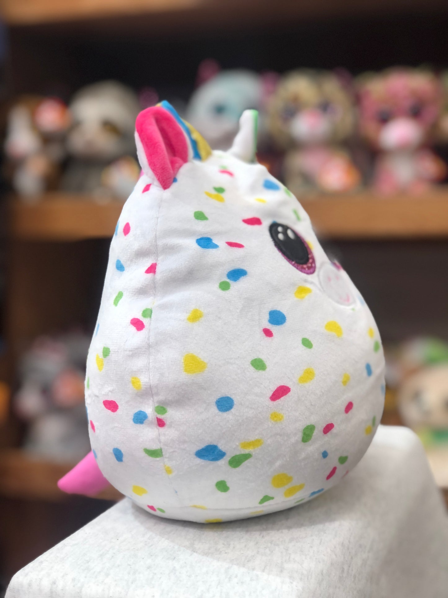 Ty Squish-a-Boo Harmonie unicorn plush with colorful spots, blue-gold horn, pink ear, and eye on white body