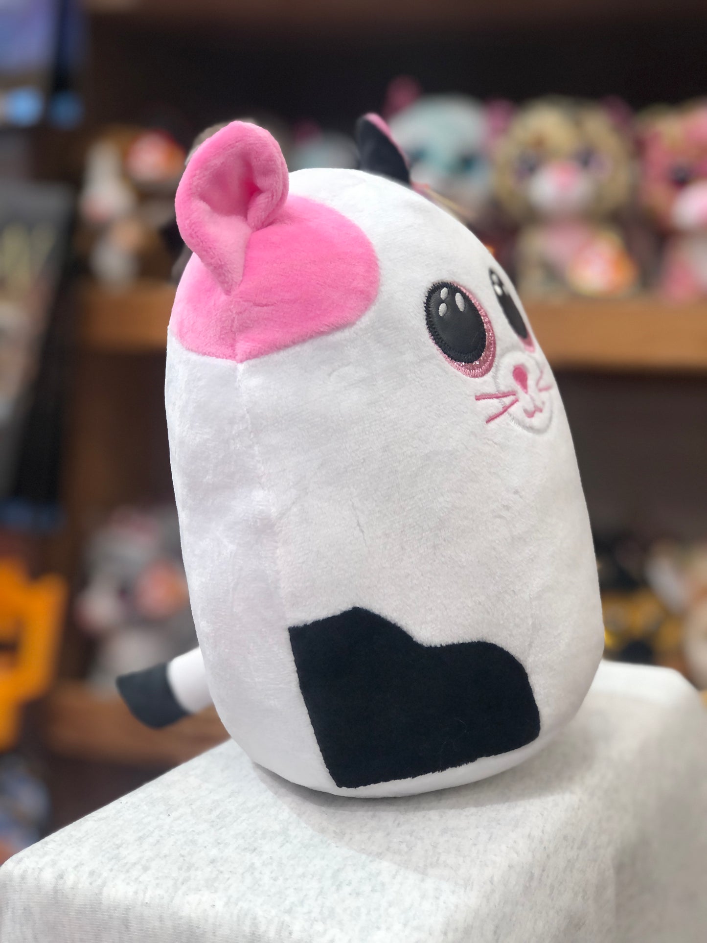 Cuddly Ty Squish-a-Boo Muffin cat plush toy with pink ears, white body, and black spot, perfect for snuggling