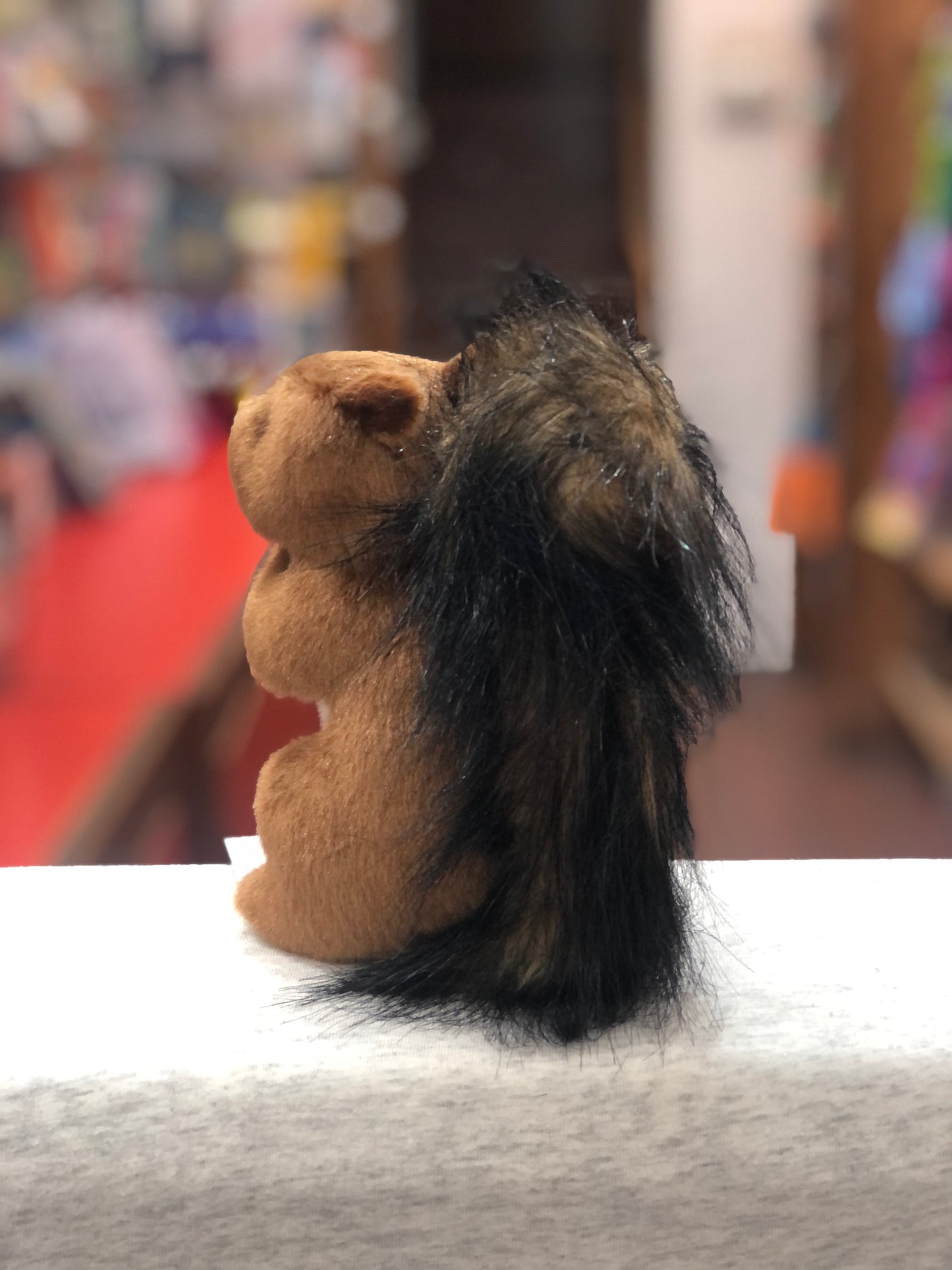 Adorable Douglas Roadie Red Squirrel plush toy with russet fur and fluffy black-tipped tail, sitting upright on display