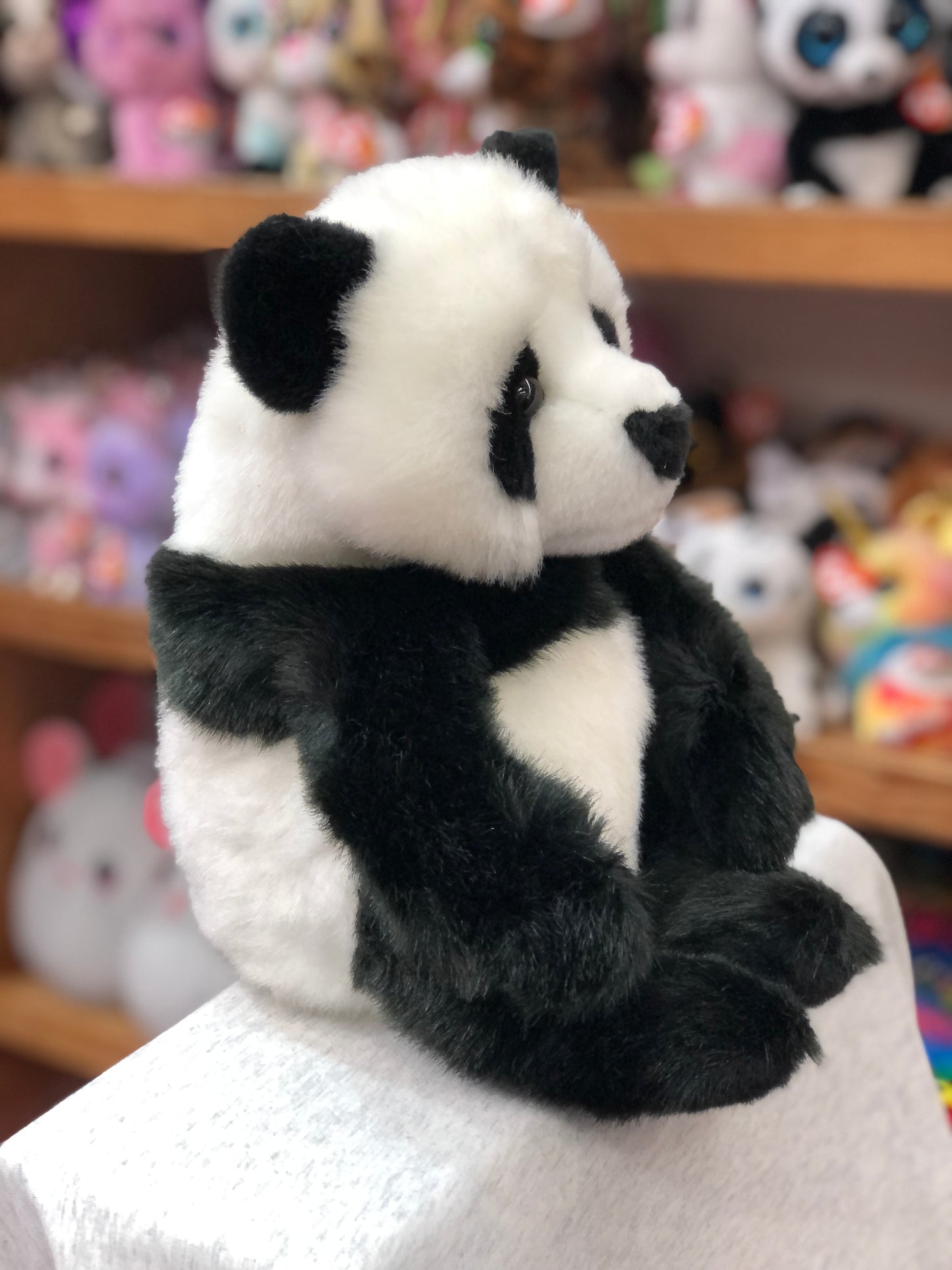 Adorable Douglas Paya panda plush toy with realistic black and white markings, seated position, and huggable form