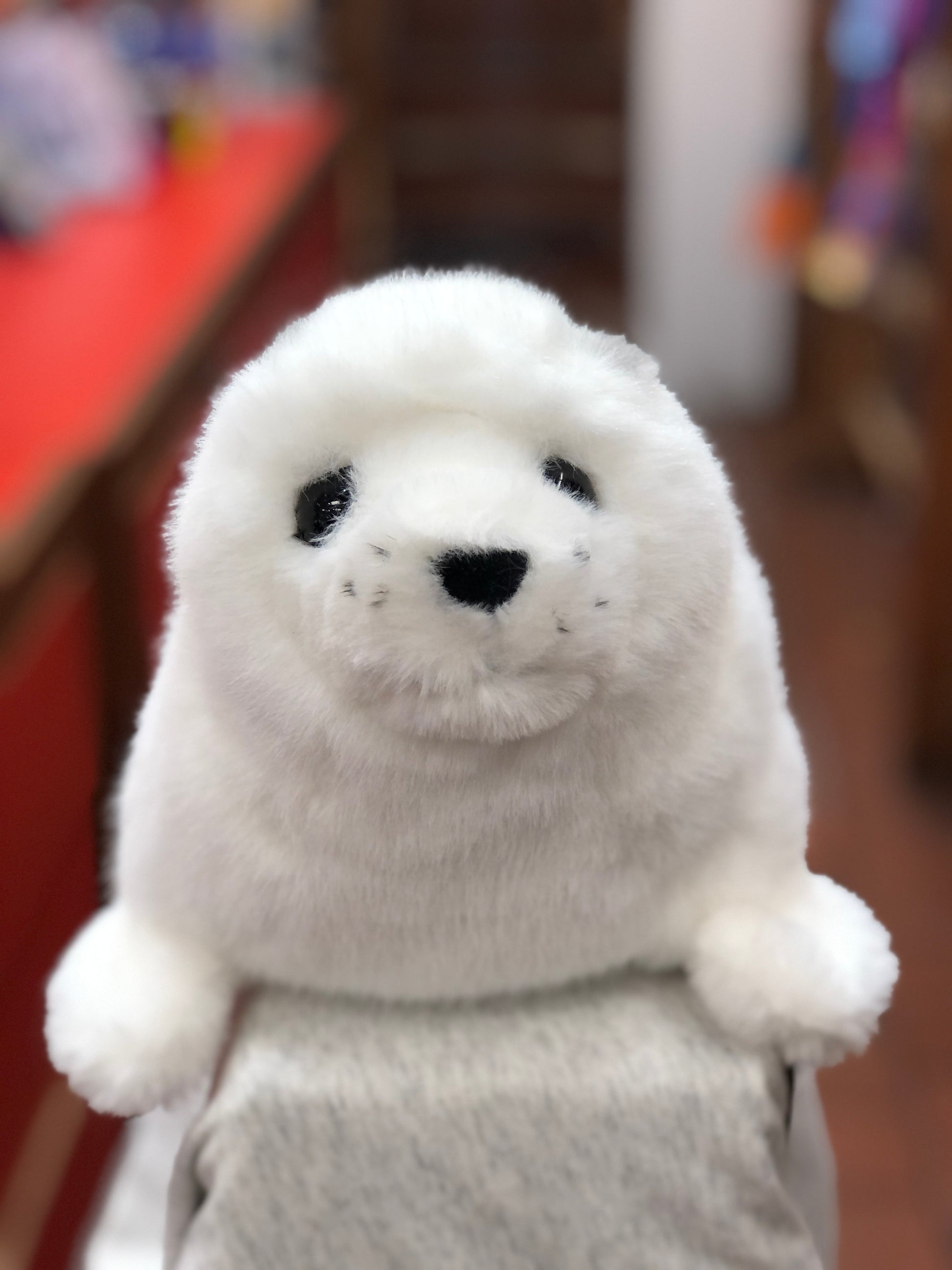 Adorable white harp seal plush toy with realistic features, soft fur, and lifelike pudgy flippers, perfect for cuddling