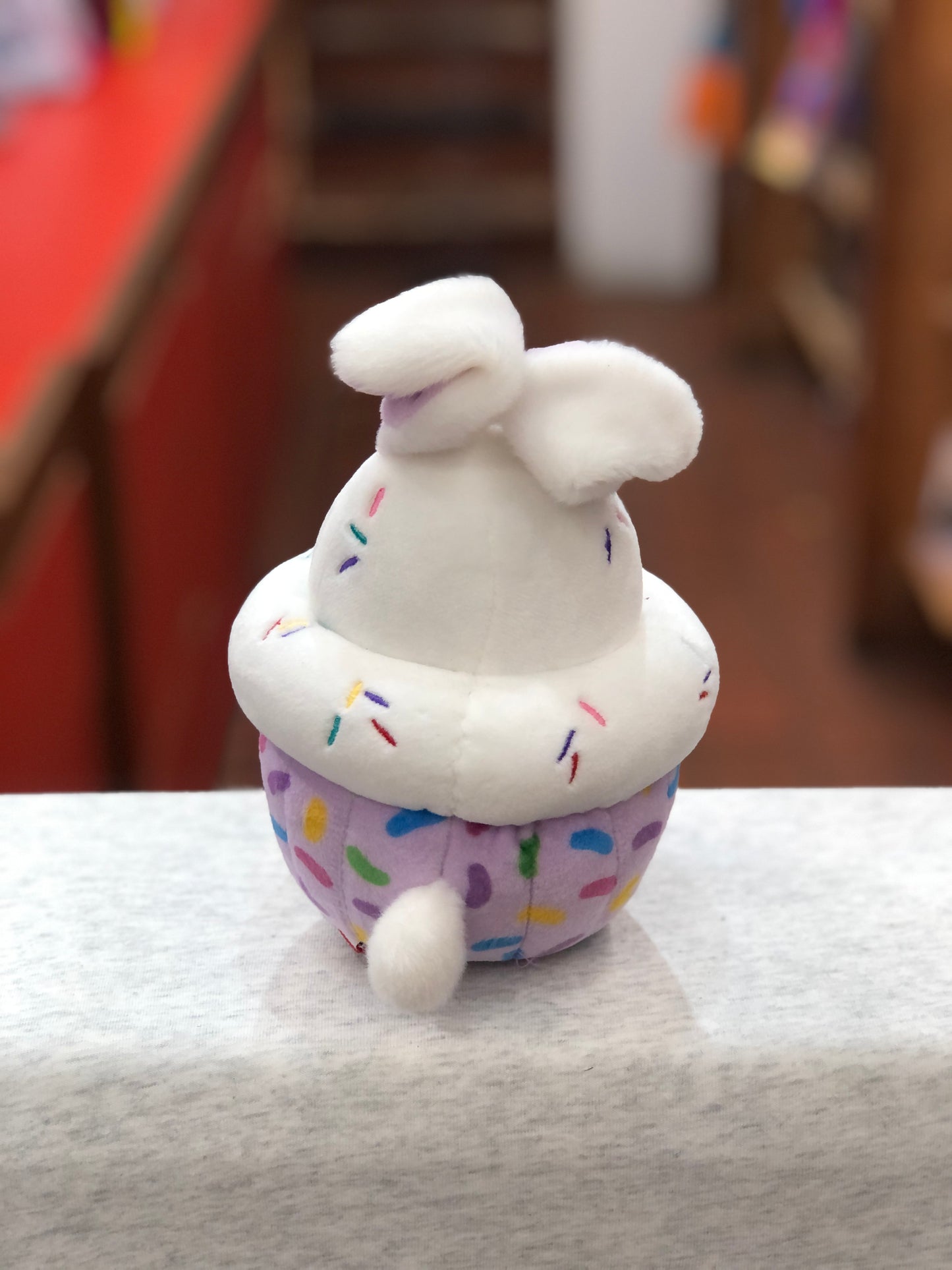 Cute bunny cupcake plush toy with white frosting, colorful sprinkles, and rabbit ears peeking out, perfect for Easter baskets