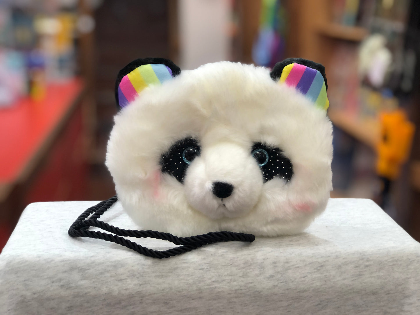Fluffy white panda crossbody purse with rainbow ears, sparkly eyes, and black strap, perfect for magical fantasy accessories
