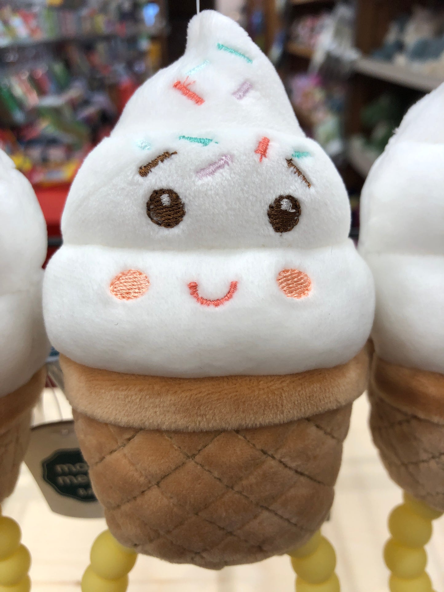 Cute plush ice cream teether rattle toy with smiling face and colorful sprinkles, perfect for soothing baby's gums