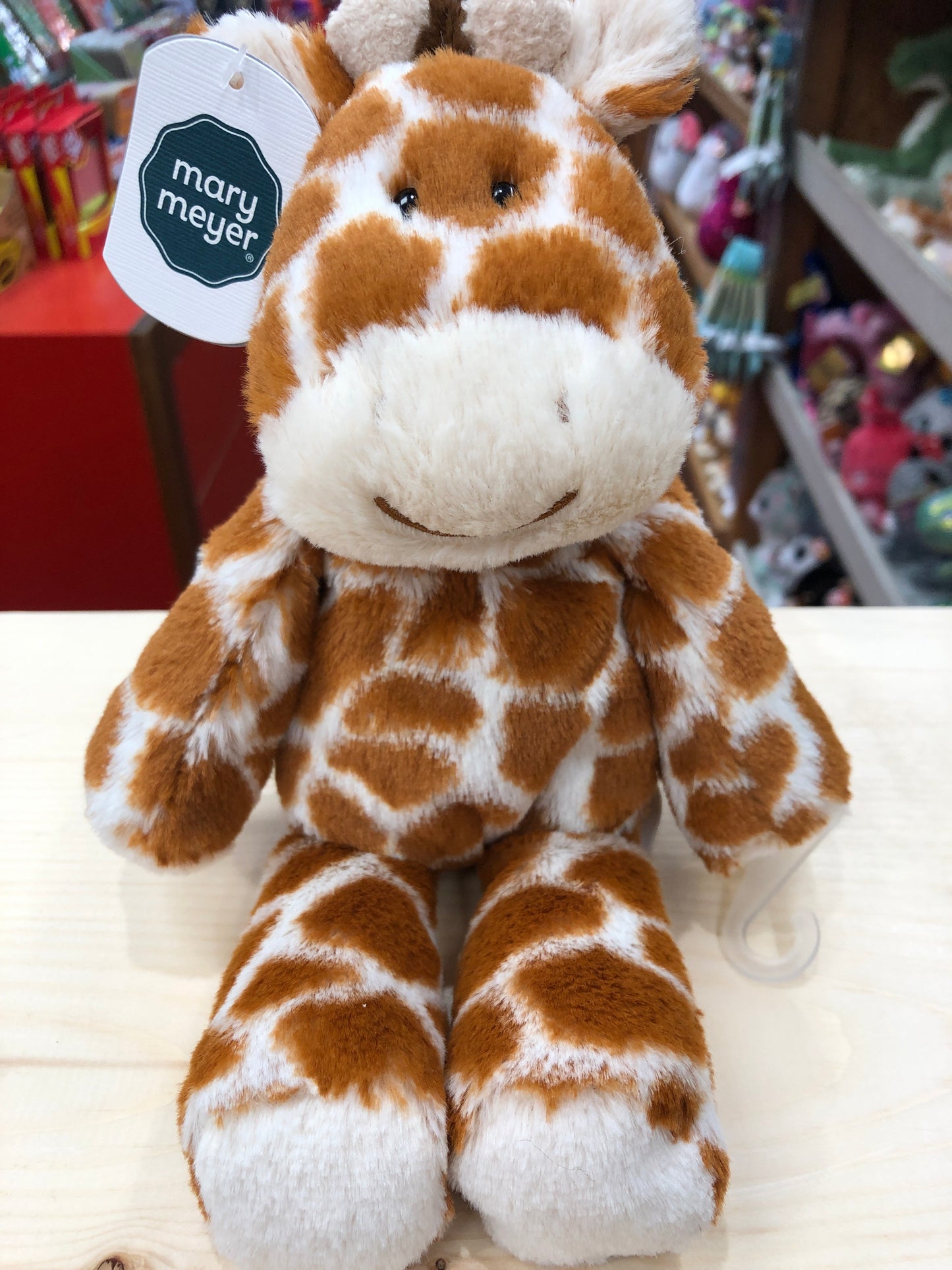 Soft and cuddly Mary Meyer 9" giraffe plush toy with spotted pattern and smiling face, perfect for snuggling