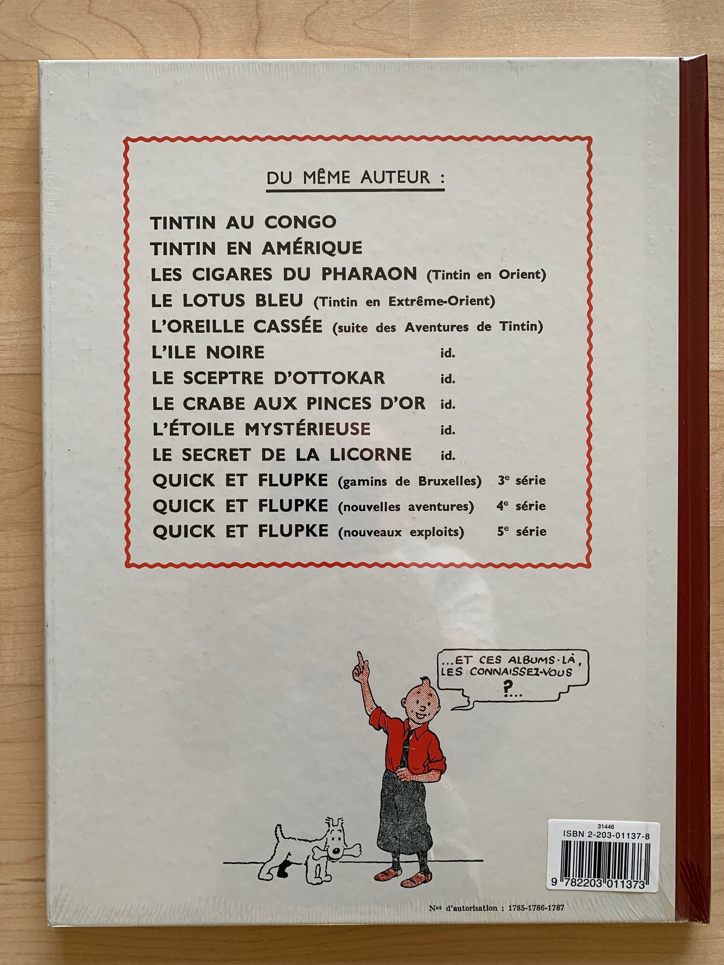 Back cover of Tintin's "L'ile Noire" book, listing other titles by Hergé, with Tintin and Snowy illustration
