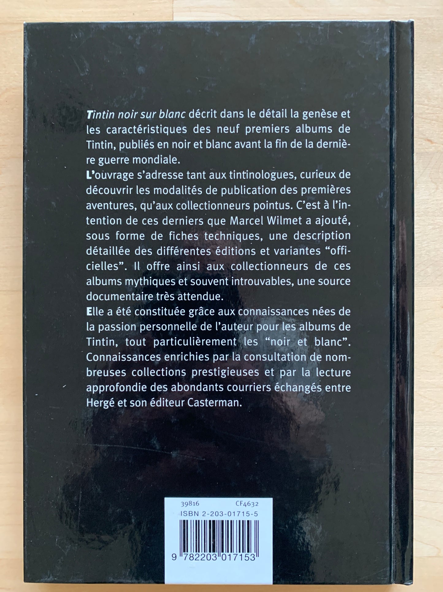 Back cover of "Tintin Noir Sur Blanc" book by Marcel Wilmet, detailing early Tintin albums in French, with ISBN barcode visible