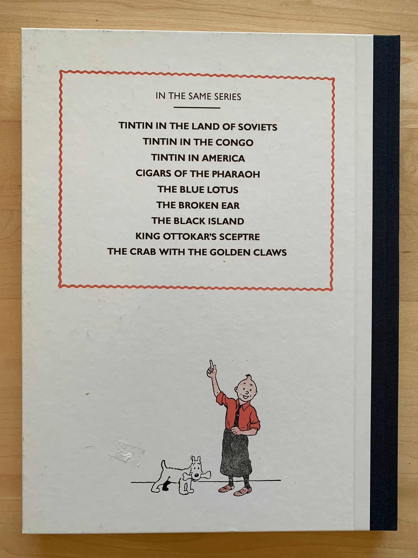 Tintin book cover listing adventures in series, with illustration of boy and dog at bottom