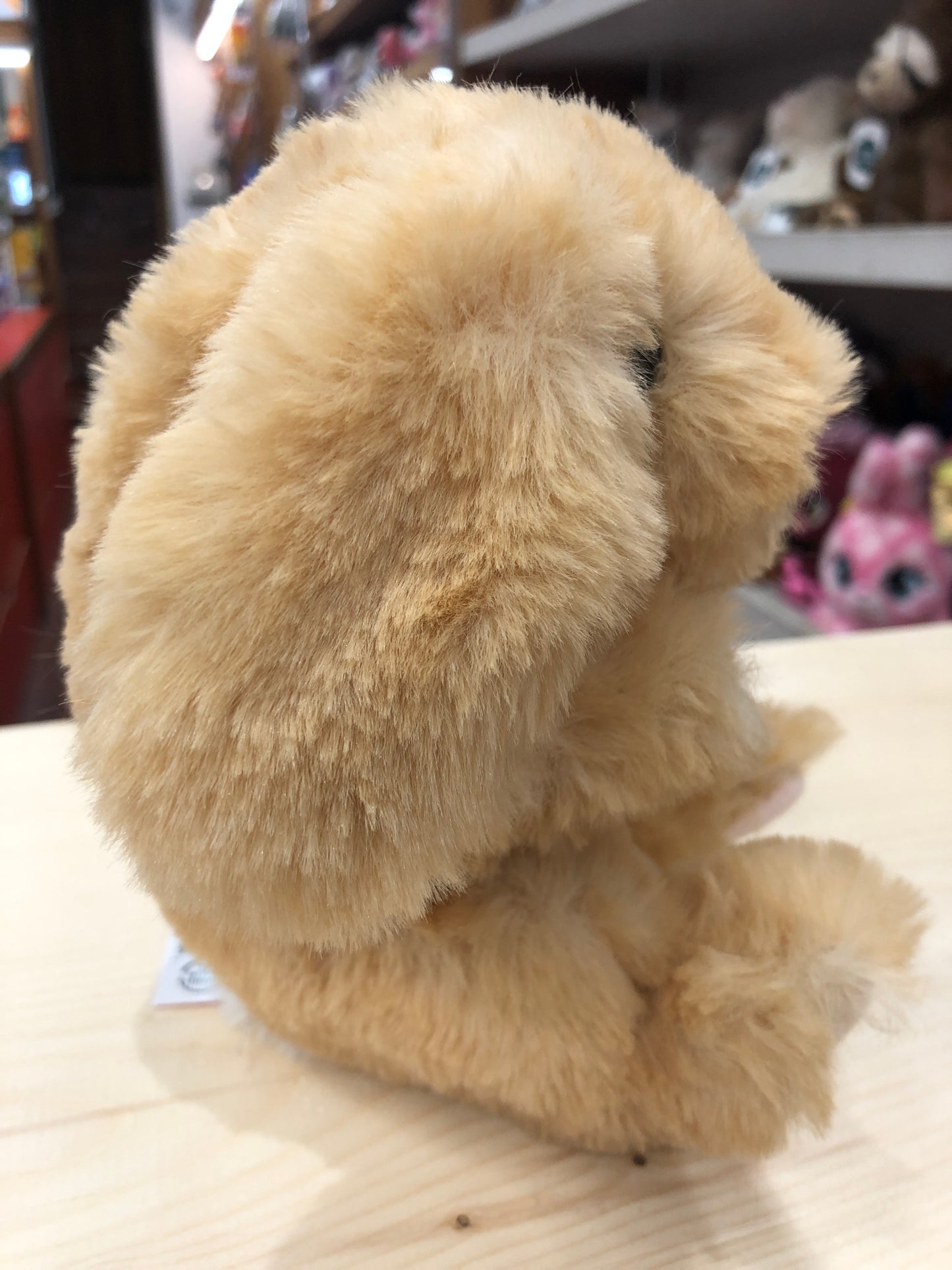 Soft golden Douglas Lil' Handful bunny plush toy sitting on display, showcasing its fluffy fur and compact 6-inch size