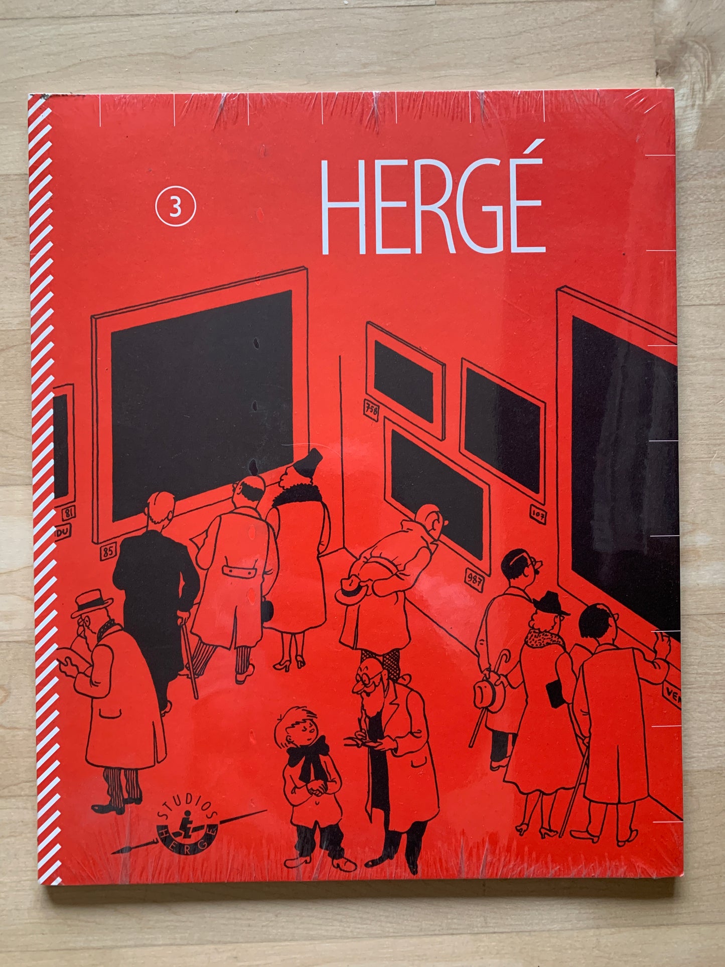 Hergé Magazine Volume 3 cover, red with cartoon figures viewing exhibition, shrink-wrapped collectible issue