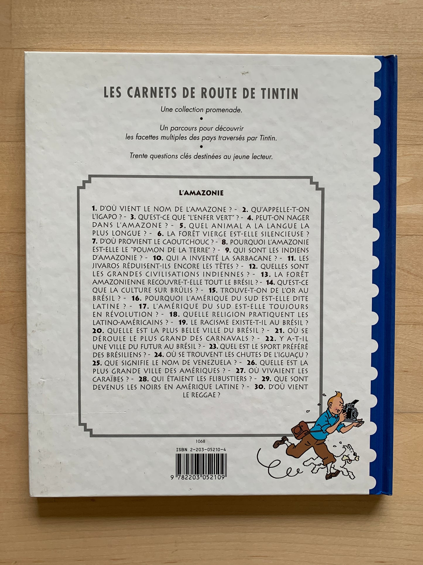 Back cover of Tintin's Amazonia travel guide, listing 30 questions about Amazon and Latin America, with cartoon character running
