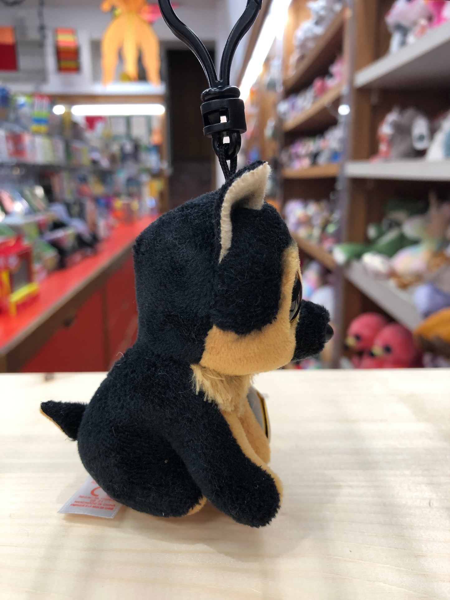Ty Beanie Boo Spirit German Shepherd plush clip on display in toy store, showcasing soft black and tan fur and large eyes