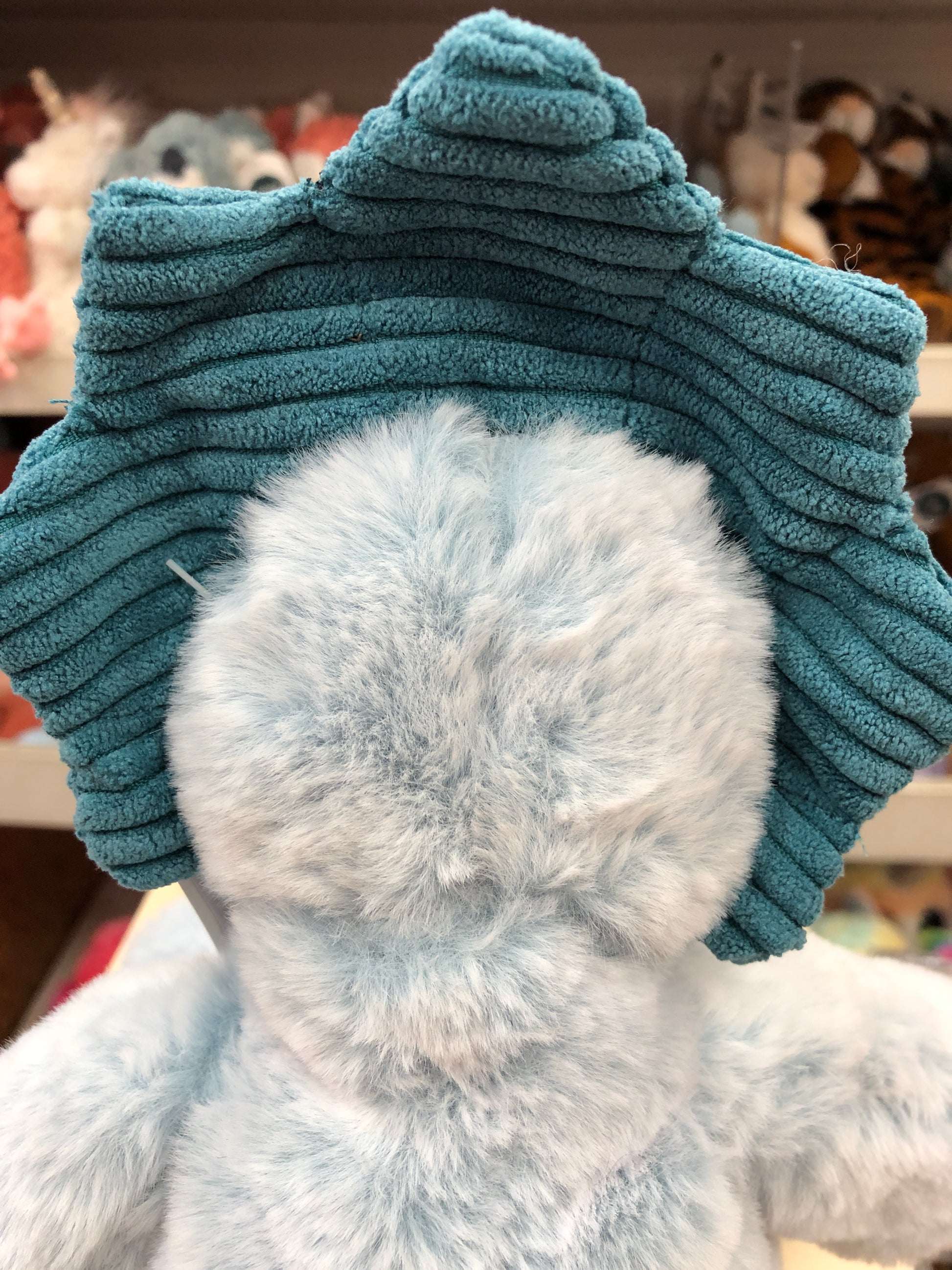 Soft blue Marshmallow Triceratops plush toy with textured teal frill, showcasing cuddly design and embroidered details