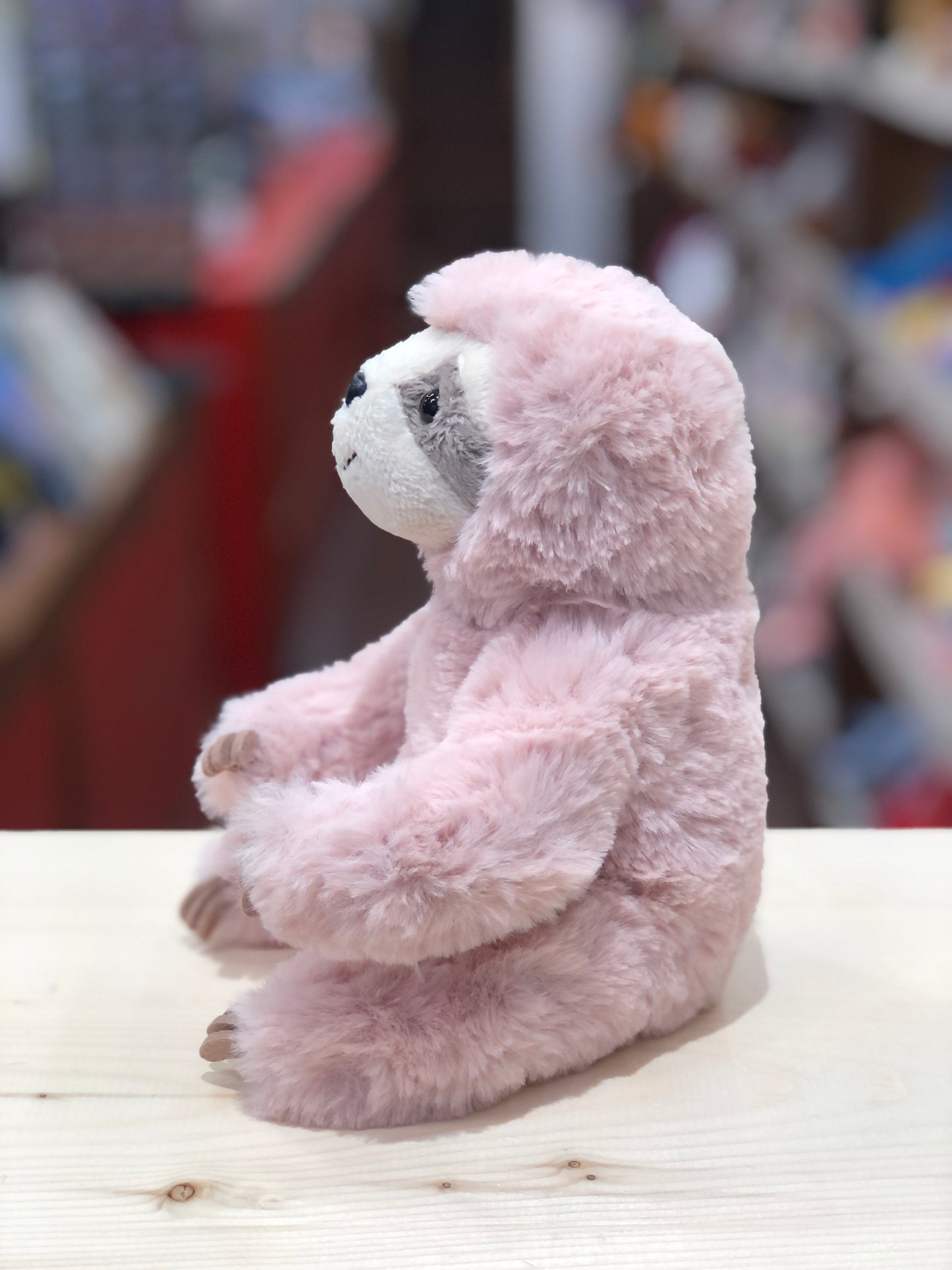 Adorable 6" Douglas Mini Pokie soft pink sloth plush toy sitting on table, fluffy fur and endearing expression