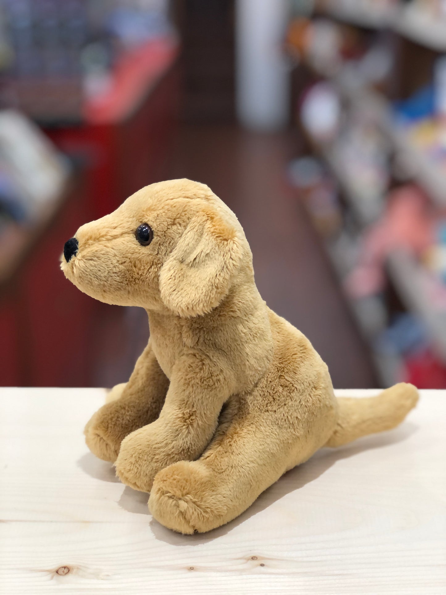 Soft plush Golden Retriever puppy Gracie, 6 inches, sitting on table with soulful eyes and fuzzy nose, perfect pocket-sized companion