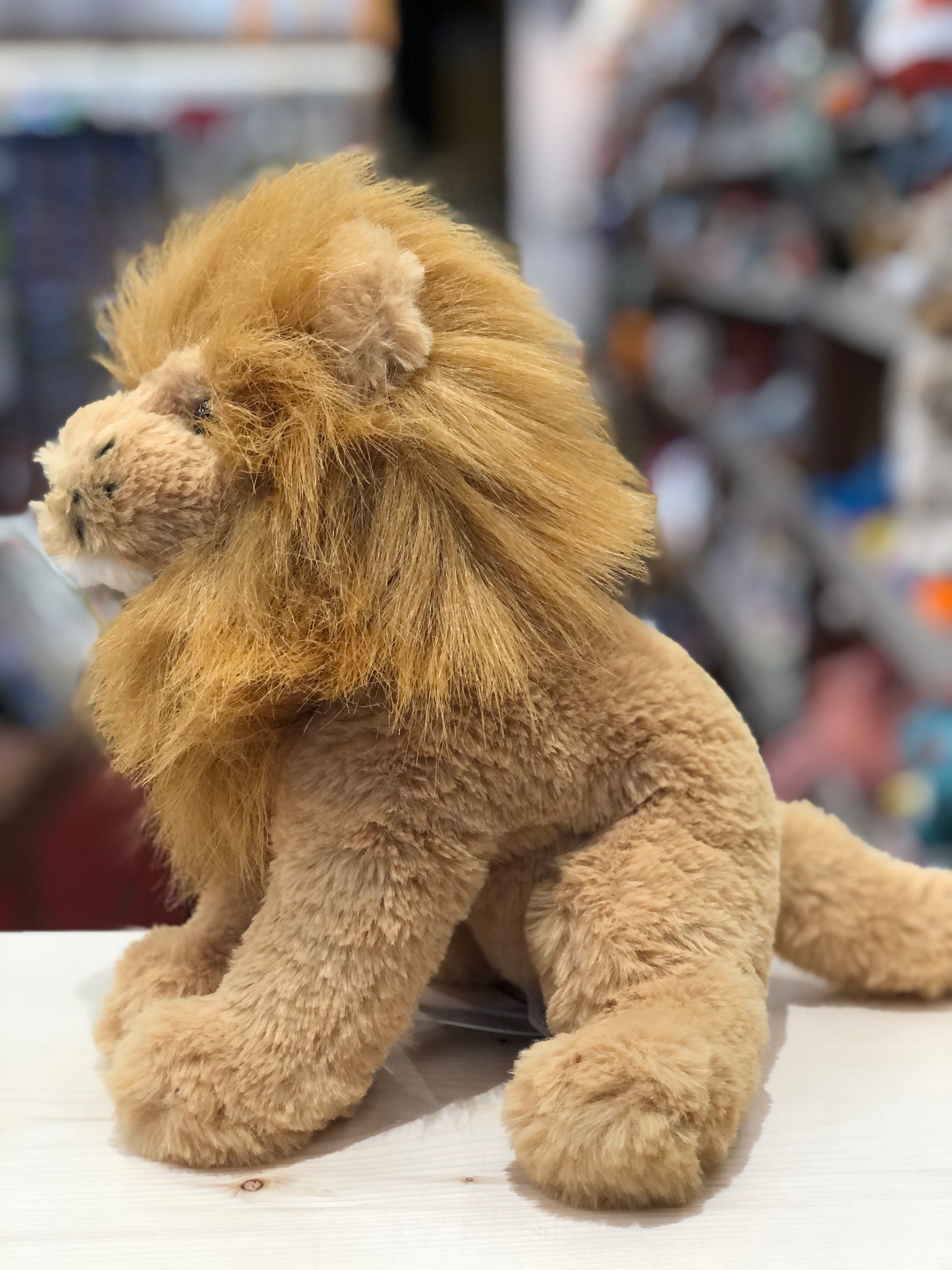 Cuddly Douglas Lennie Soft Lion Plush with fluffy mane and ultra-soft tawny body, sitting on display in toy store