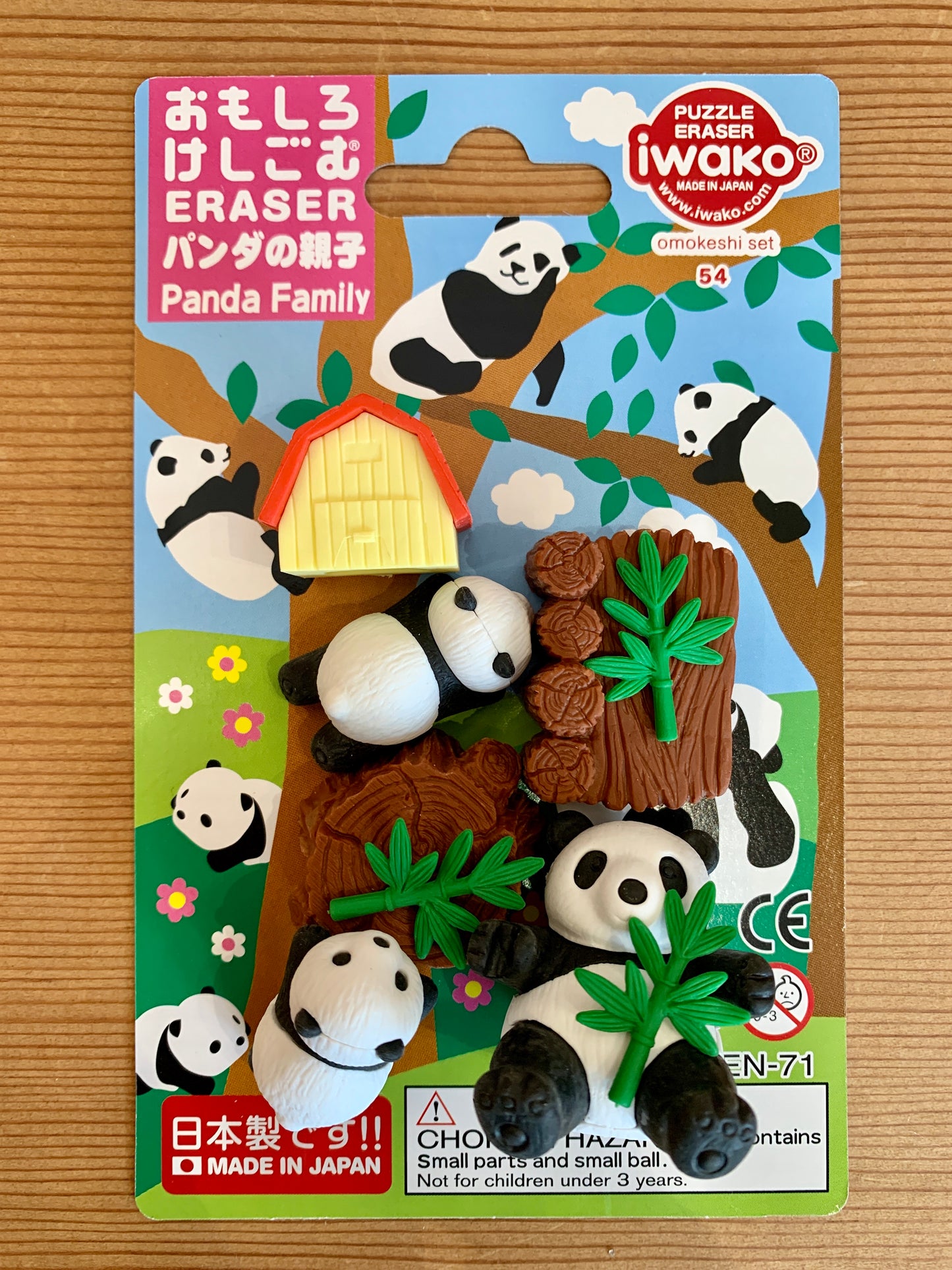Iwako Japanese Panda Family eraser set with pandas, bamboo, shed, and stump. Colorful packaging shows cartoon panda scene.