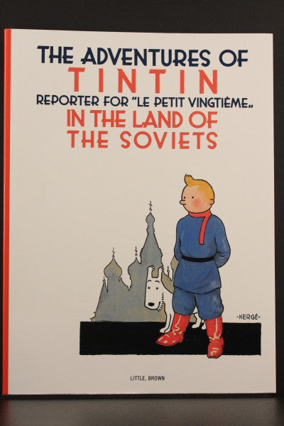 Cover of Tintin paperback "In the Land of the Soviets" featuring cartoon character with dog against Russian church backdrop