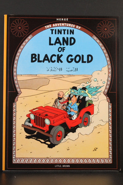 Tintin comic book cover "Land of Black Gold" showing characters in red jeep driving through desert landscape