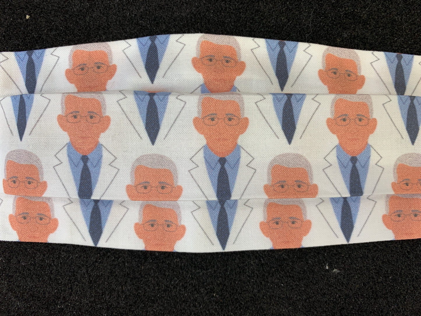Cotton Covid mask with cartoon pattern of scientist in blue suit and tie, repeating design on white fabric