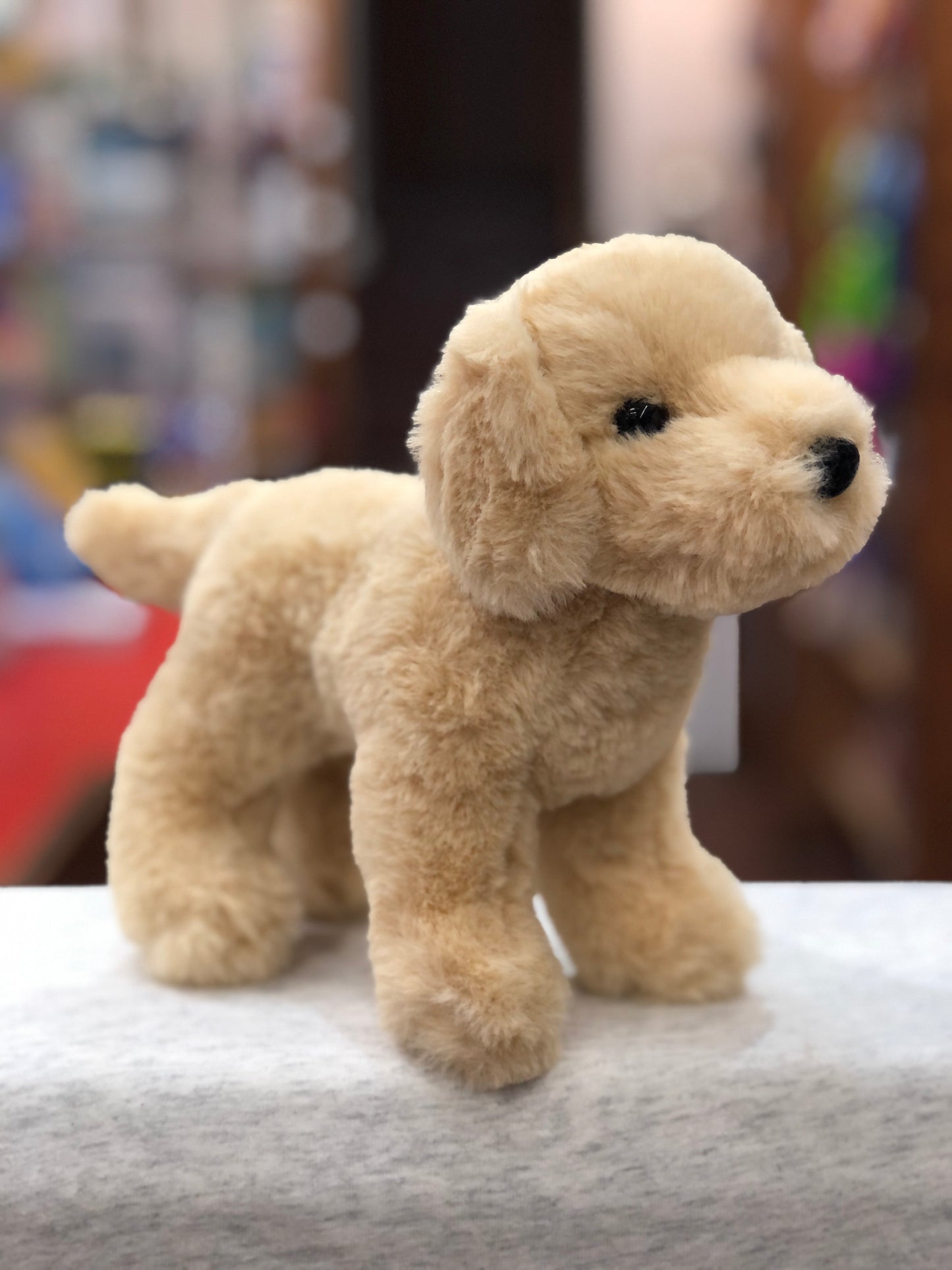 Realistic Douglas Cornell Yellow Lab plush toy standing on display, soft cream fur and lifelike features