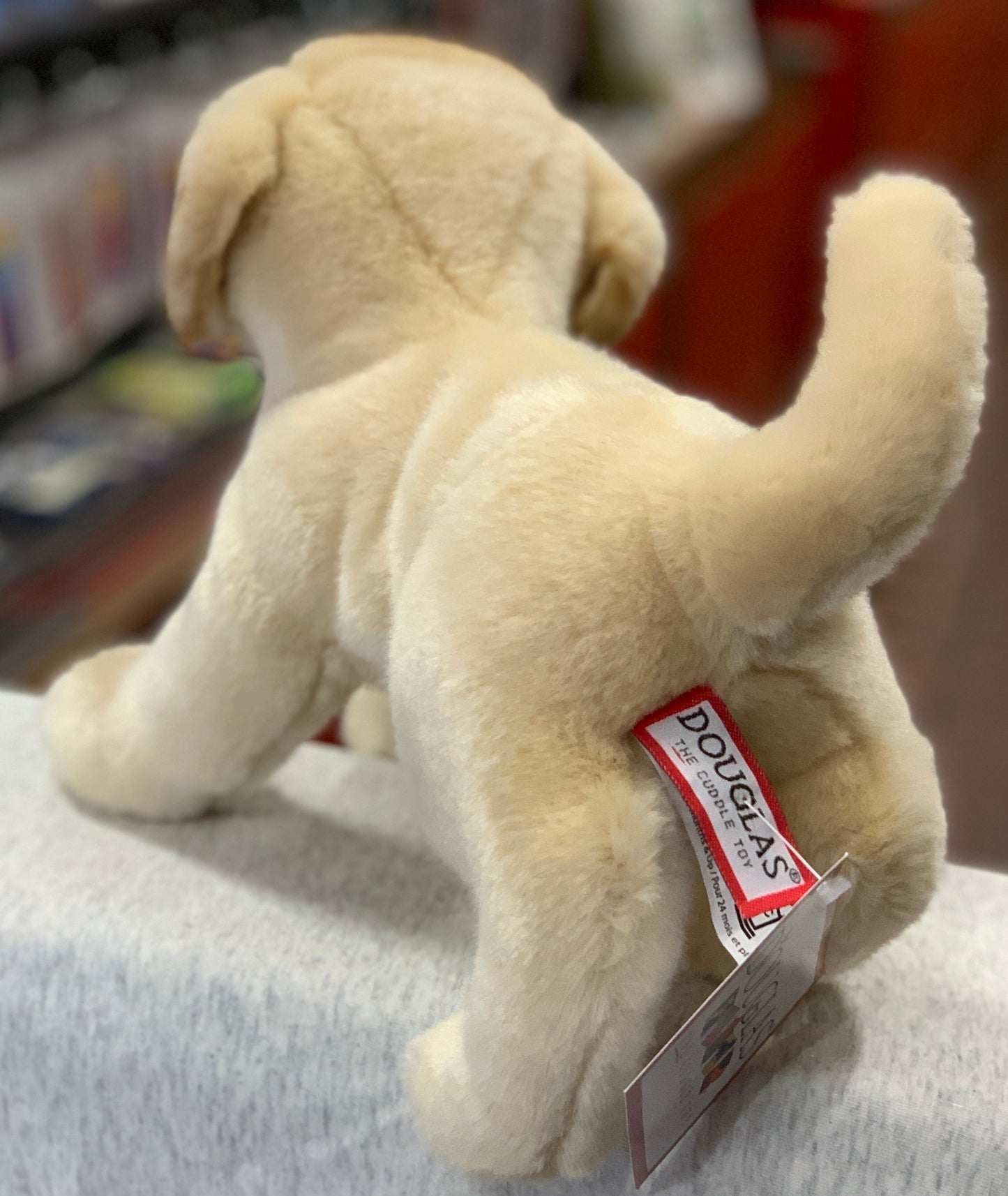 Realistic Douglas Spankie yellow Labrador plush toy, soft fur, playful pose, with brand tag visible