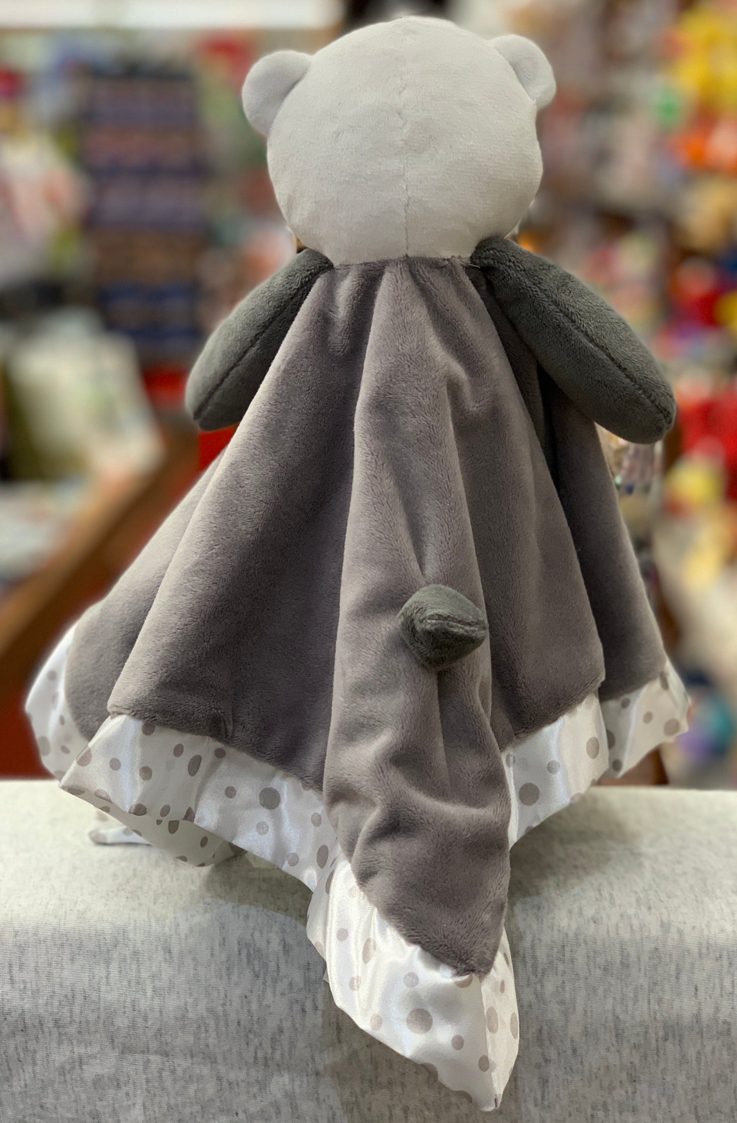 Soft gray panda baby snuggler plush with white head and polka dot trim, perfect for cuddling and nursery decor