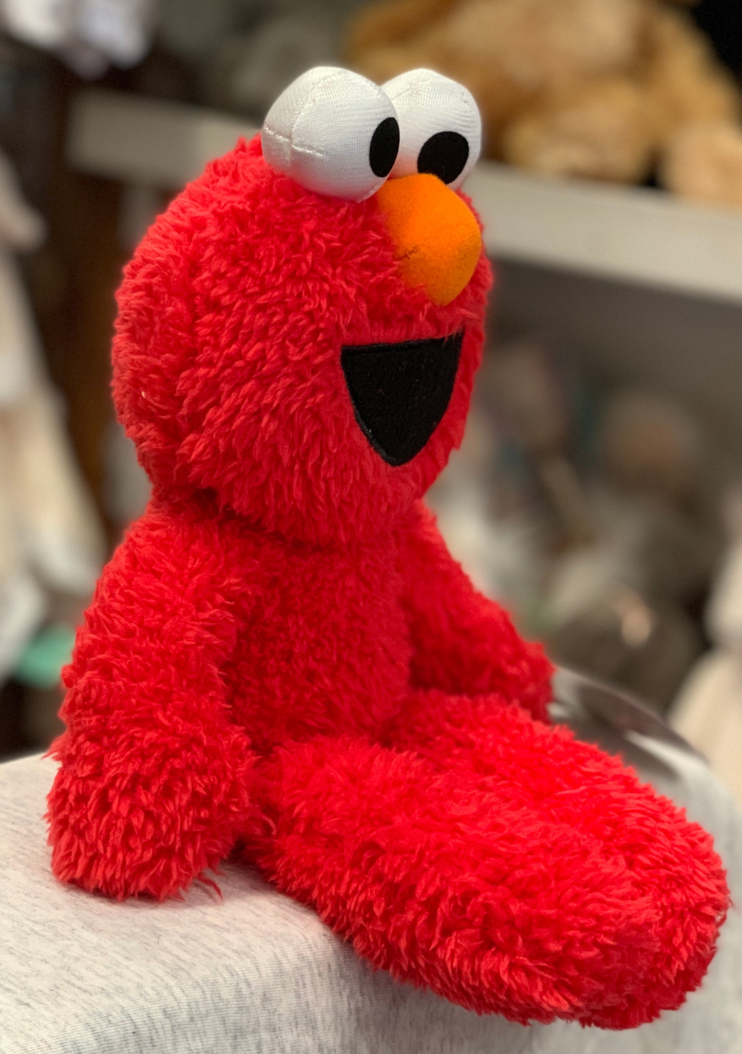 Gund Sesame Street Elmo plush toy with soft red fur, large eyes, and orange nose, perfect for take-along adventures