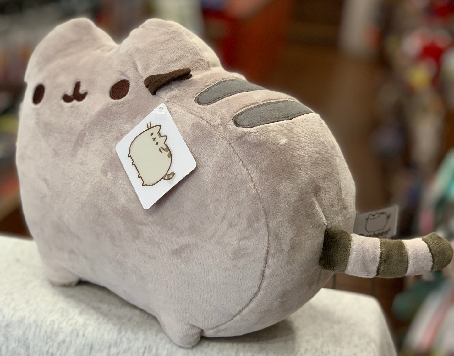 Gund Pusheen plush toy, gray cat with cute face, striped tail, and character tag, soft and squishy 12-inch stuffed animal