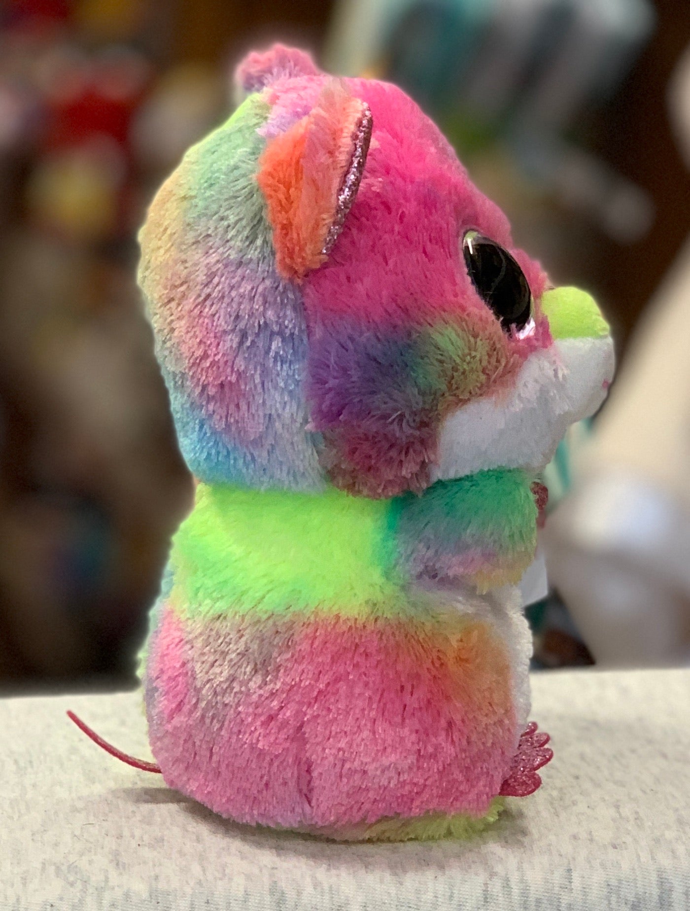 Colorful Ty Beanie Boo Rodney Hamster plush toy with rainbow fur, large sparkly eyes, and soft cuddly appearance