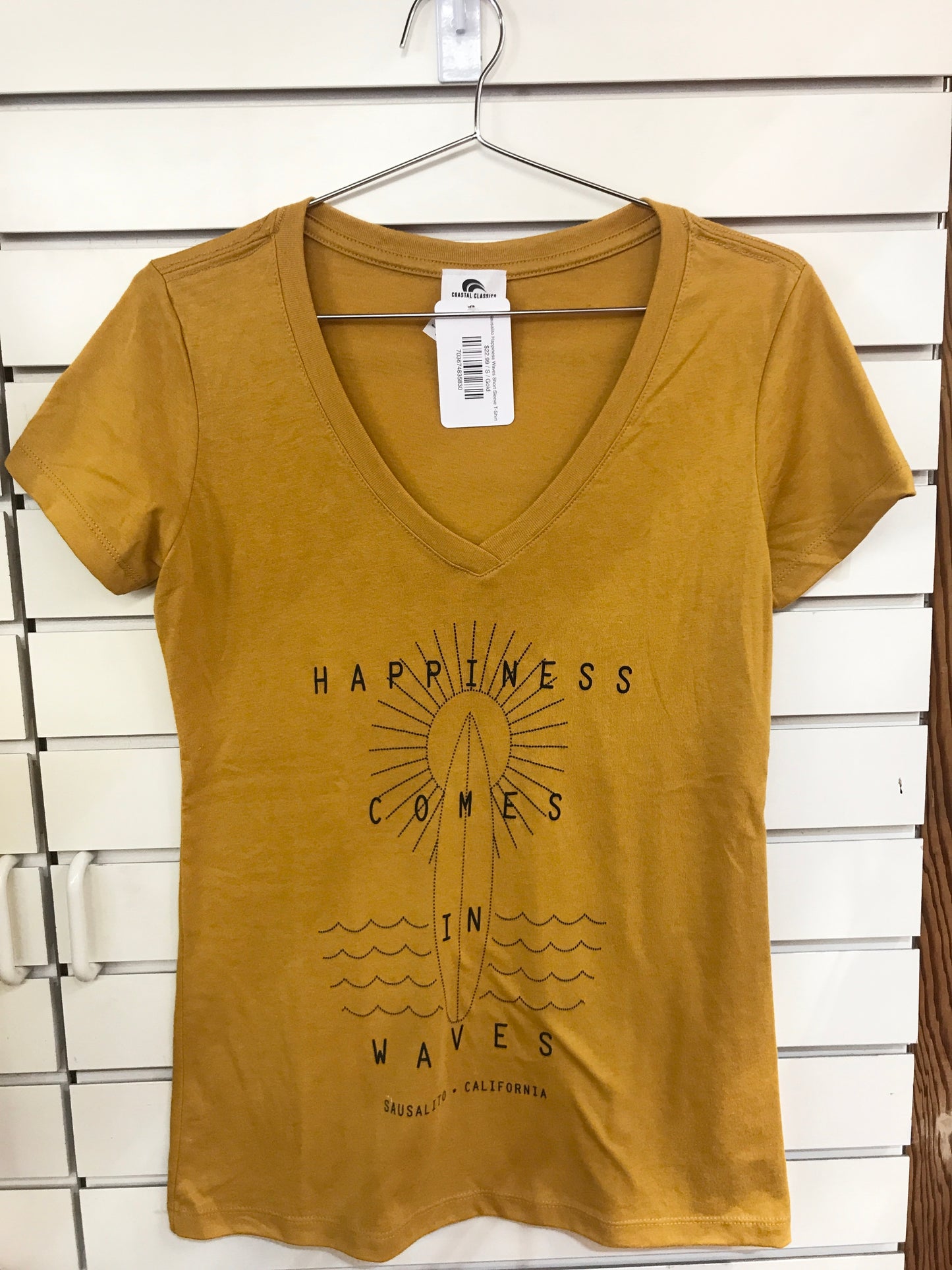 Mustard yellow women's v-neck t-shirt with "Happiness Comes in Waves" design featuring sun, surfboard, and waves for Sausalito, California