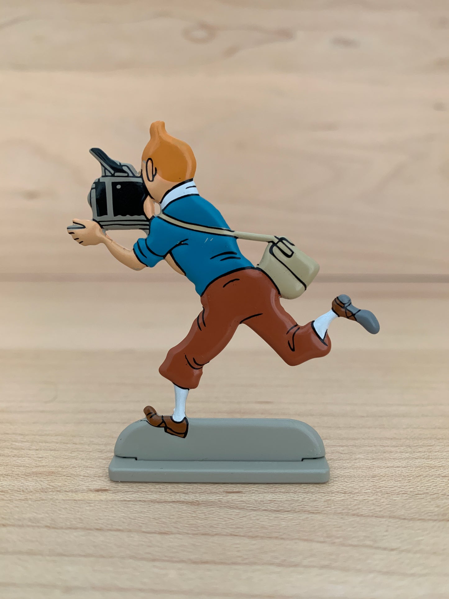 Vintage Tintin metal figure running with camera, depicting reporter in action from 1953 magazine issue